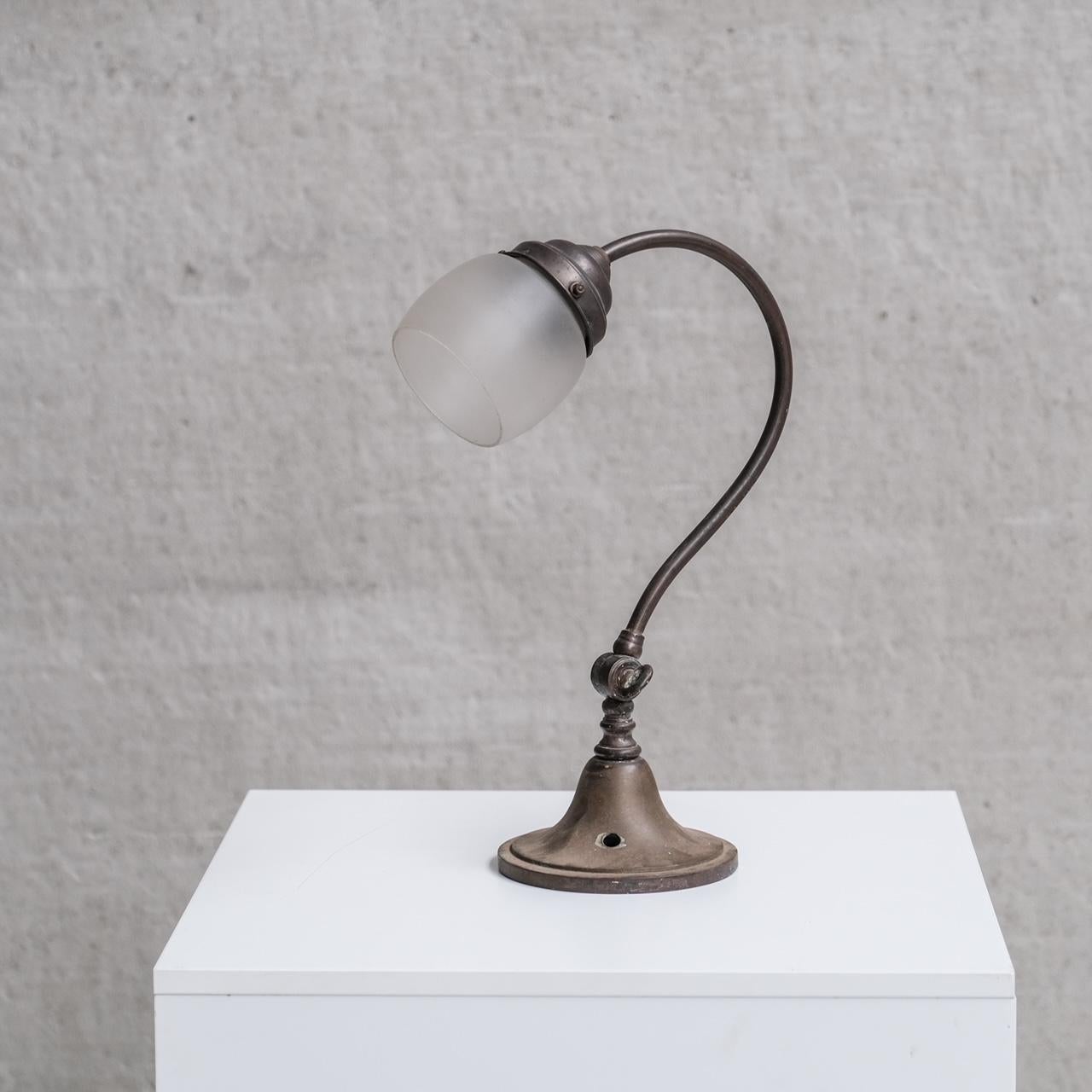 An antique metal table lamp.

France, c1930s.

Naturally patinated metal, paired with an open frosted glass shade.

Since re-wired and PAT tested.

Internal ref: 27/12/23/014.

Good vintage condition, some scuffs and wear commensurate with