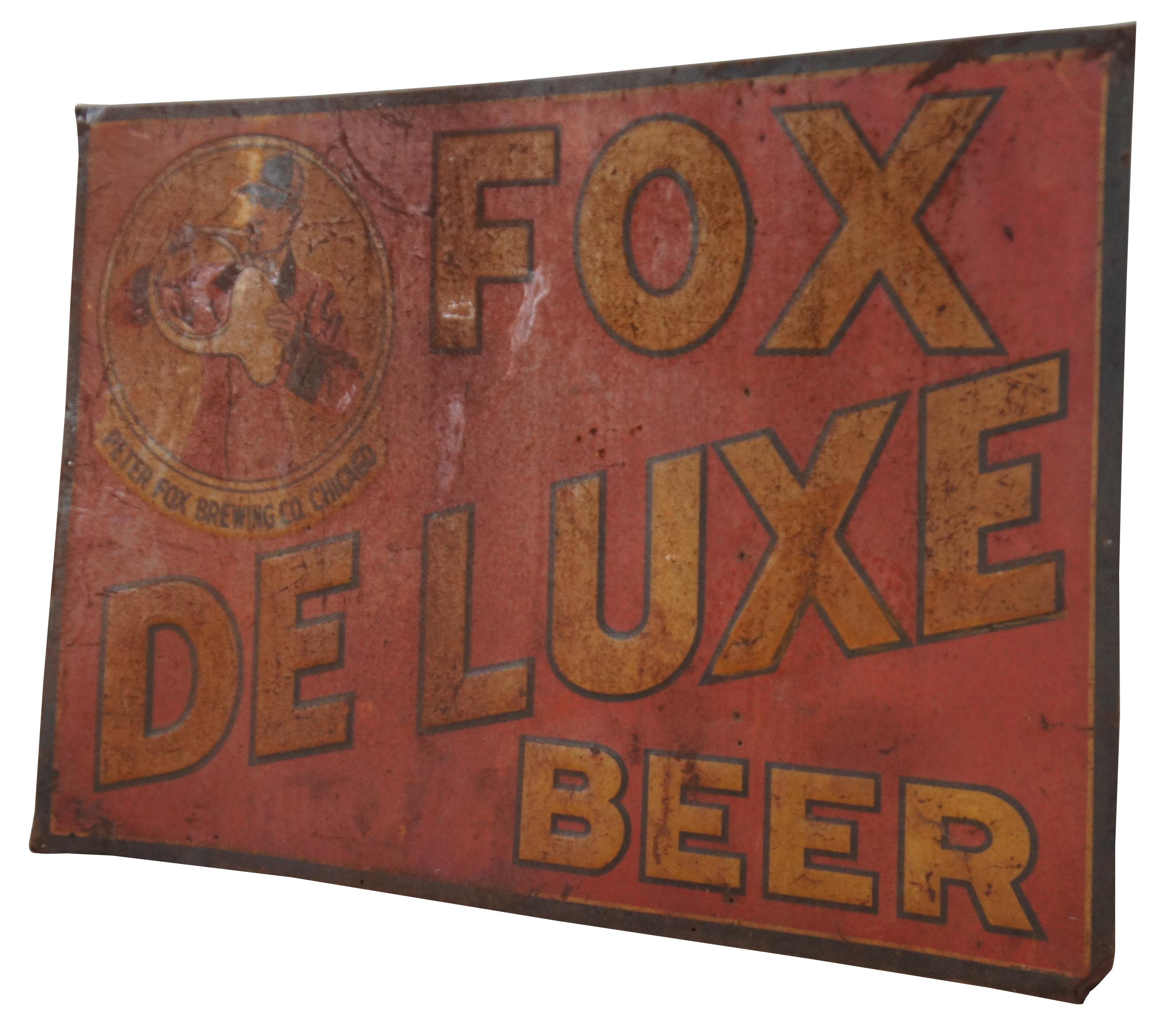 Antique yellow and red painted metal sign advertising Fox Deluxe Beer by Peter Fox Brewing Company of Chicago, Illinois. The sign features a foxhunt scene with a field guide dressed in traditional English hunt attire blowing a coiled French horn.