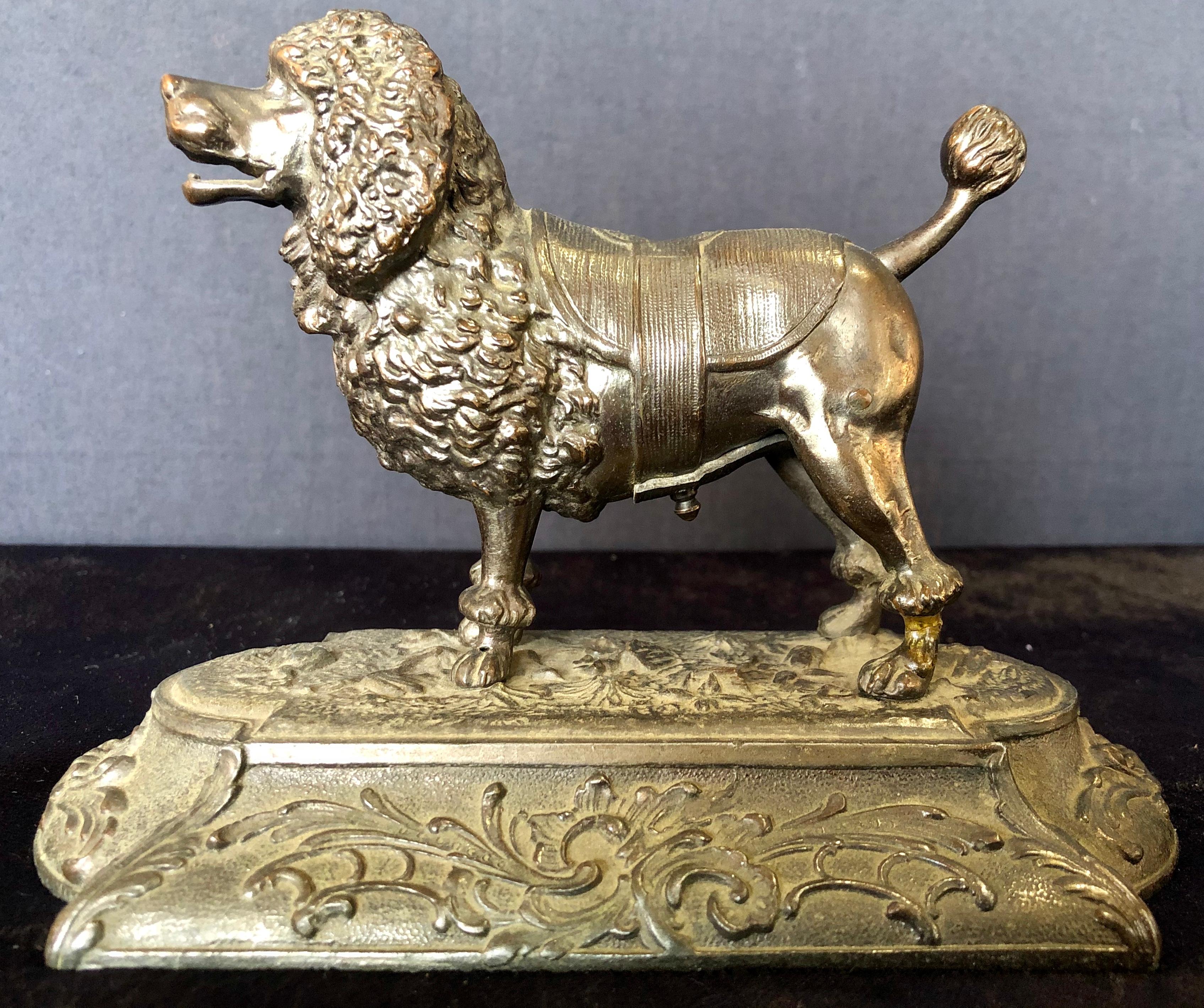 Antique metal poodle dog cigar cutter. Rare antique mechanical poodle dog, cigar cutter. It's a mechanized cigar cutter. Just insert the tip of a small cigar or cheroot, then you push down on his tail and an internal mechanism cuts the tip from your
