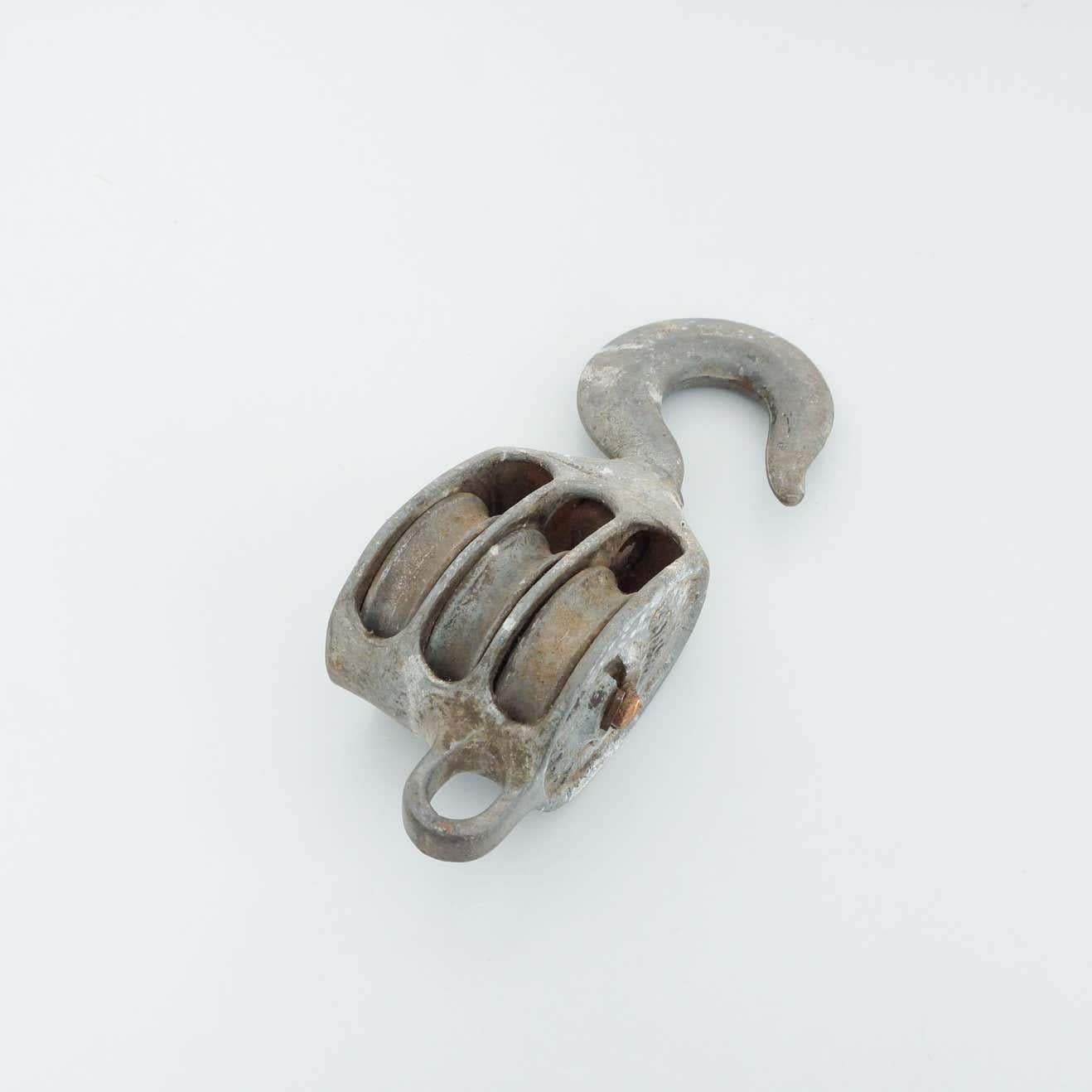 Antique Metal Pulley Hook, circa 1960.  By unknown manufacturer, Spain.    In original condition, with minor wear consistent with age and use, preserving a beautiful patina.    Materials:  Metal    Dimensions:  D 10 cm x W 14 cm x H 31 cm.
