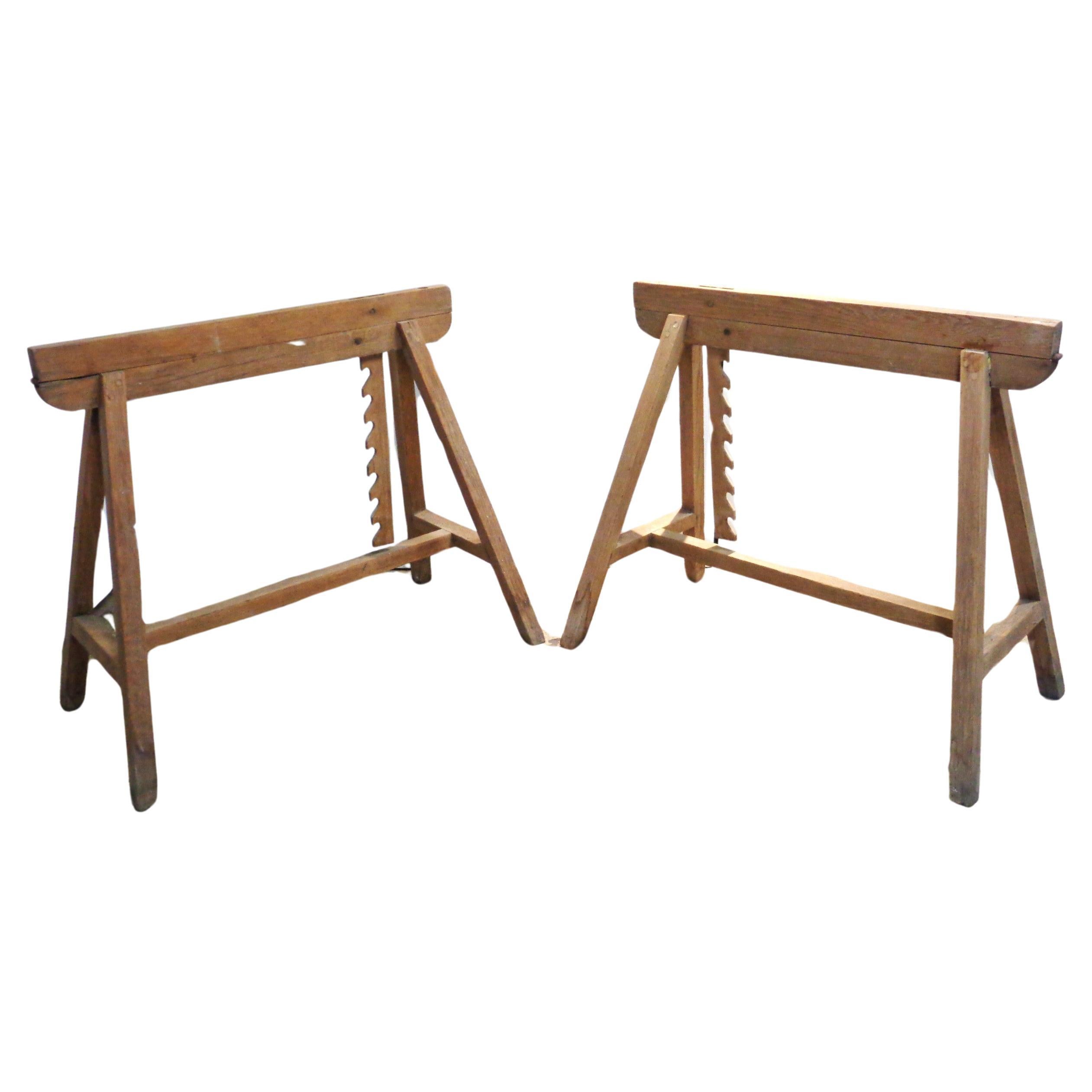 A rare pair of antique adjustable oak draftsman sawhorses with early pegged joinery construction / top boards with metal hinges / sawtooth wood planks which lock into dowels on framework to raise or lower the angle ( 7 different positions )
