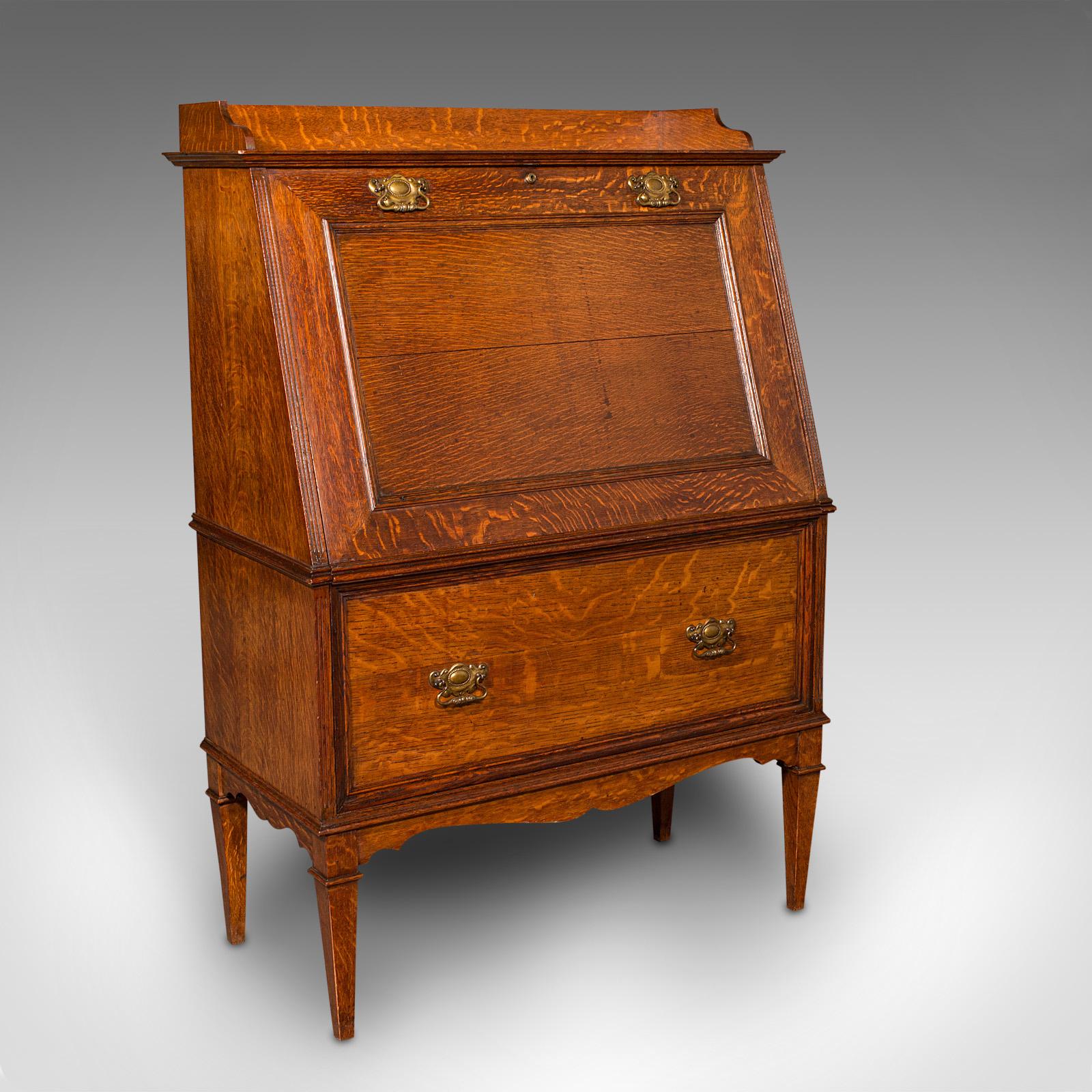 This is an antique metamorphic drinks cabinet. An English, oak bureau form cocktail cabinet, dating to the late Victorian period, circa 1900.

Superior cabinetry with astonishing oak stocks and a delightful bureau form
Displays a desirable aged