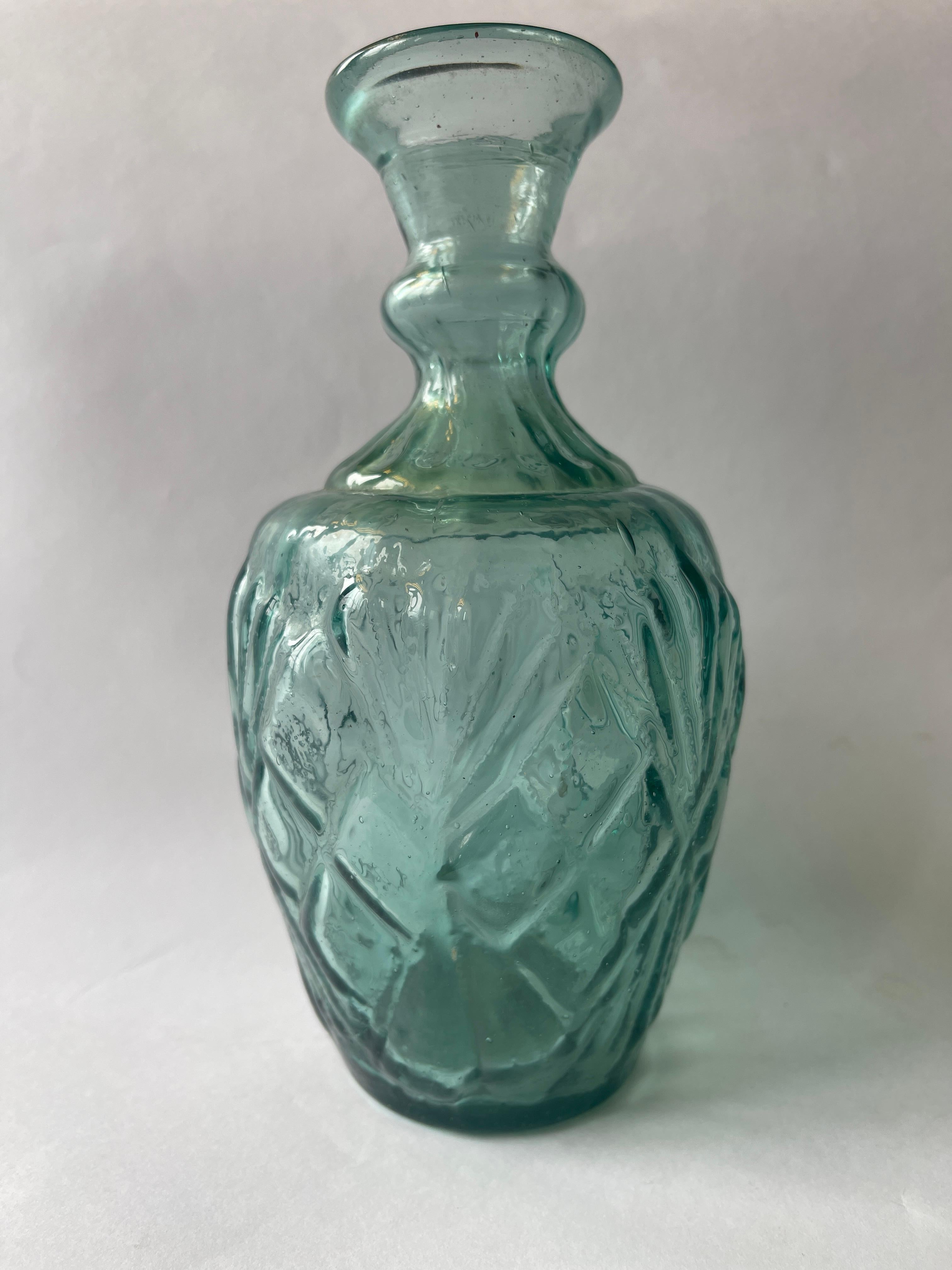 Antique Mexican aquamarine glass vase with textured Moorish design.
Beautiful dreamy color when that has a lightness of being.