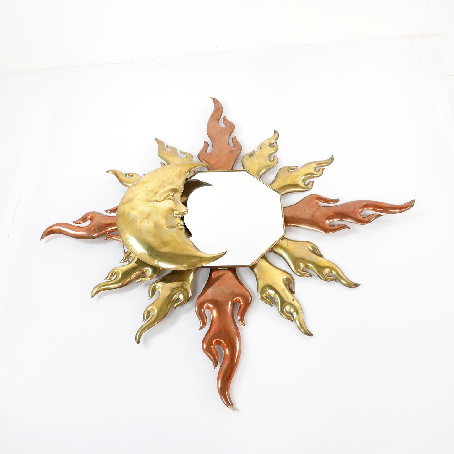 Circa 1970, we offer this Antique Mexican Artisanal Sun and Moon Mirror with light. Made in copper and brass details the mirror presents great patina.