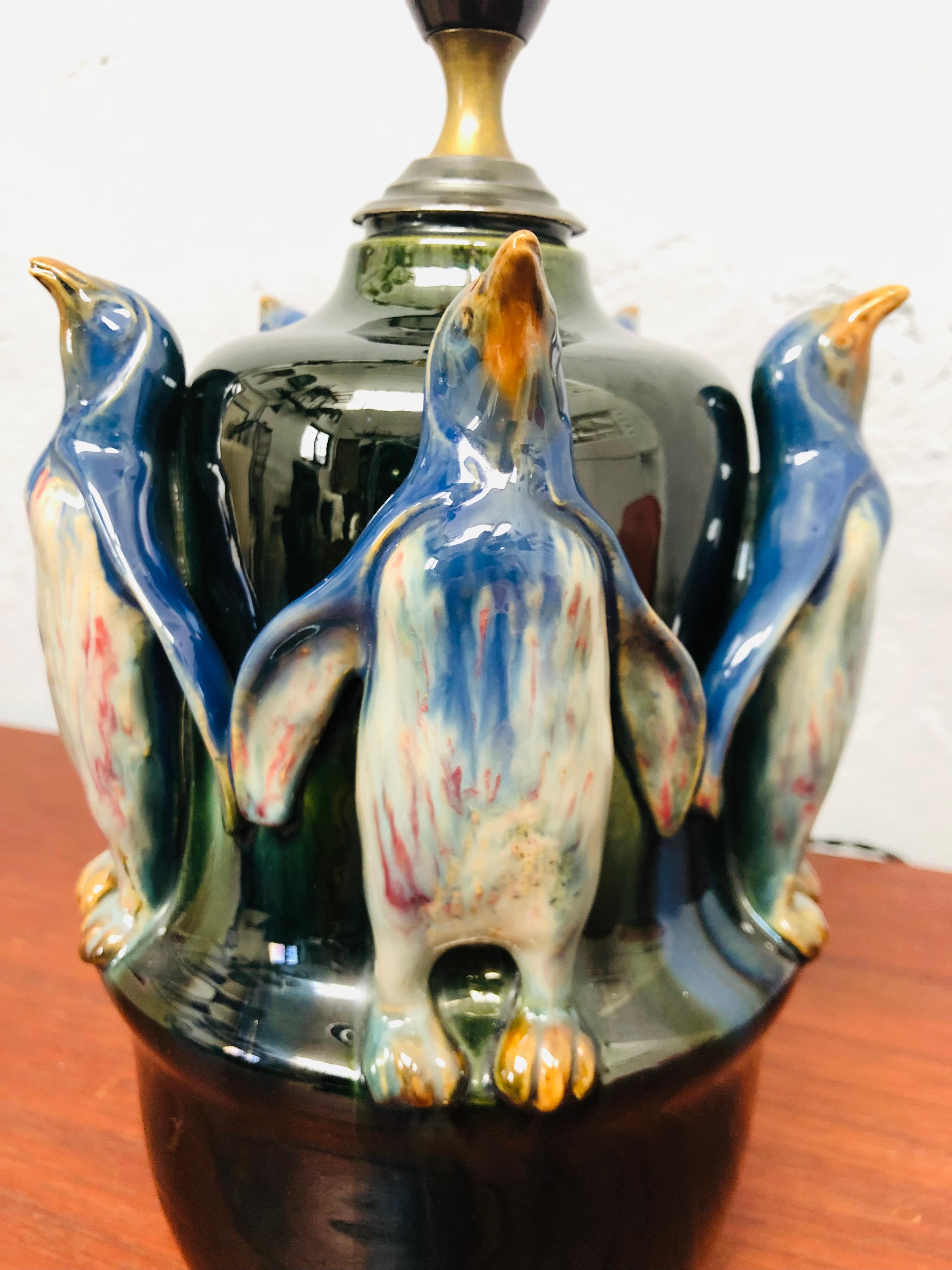Antique pottery table lamp made by Michael Andersen & Son of Bornholm with penguins. 
5 Standing penguins around the core of the lamp. 
A very recognizable Michael Andersen glaze to the surface. 
In great condition for its age with very little