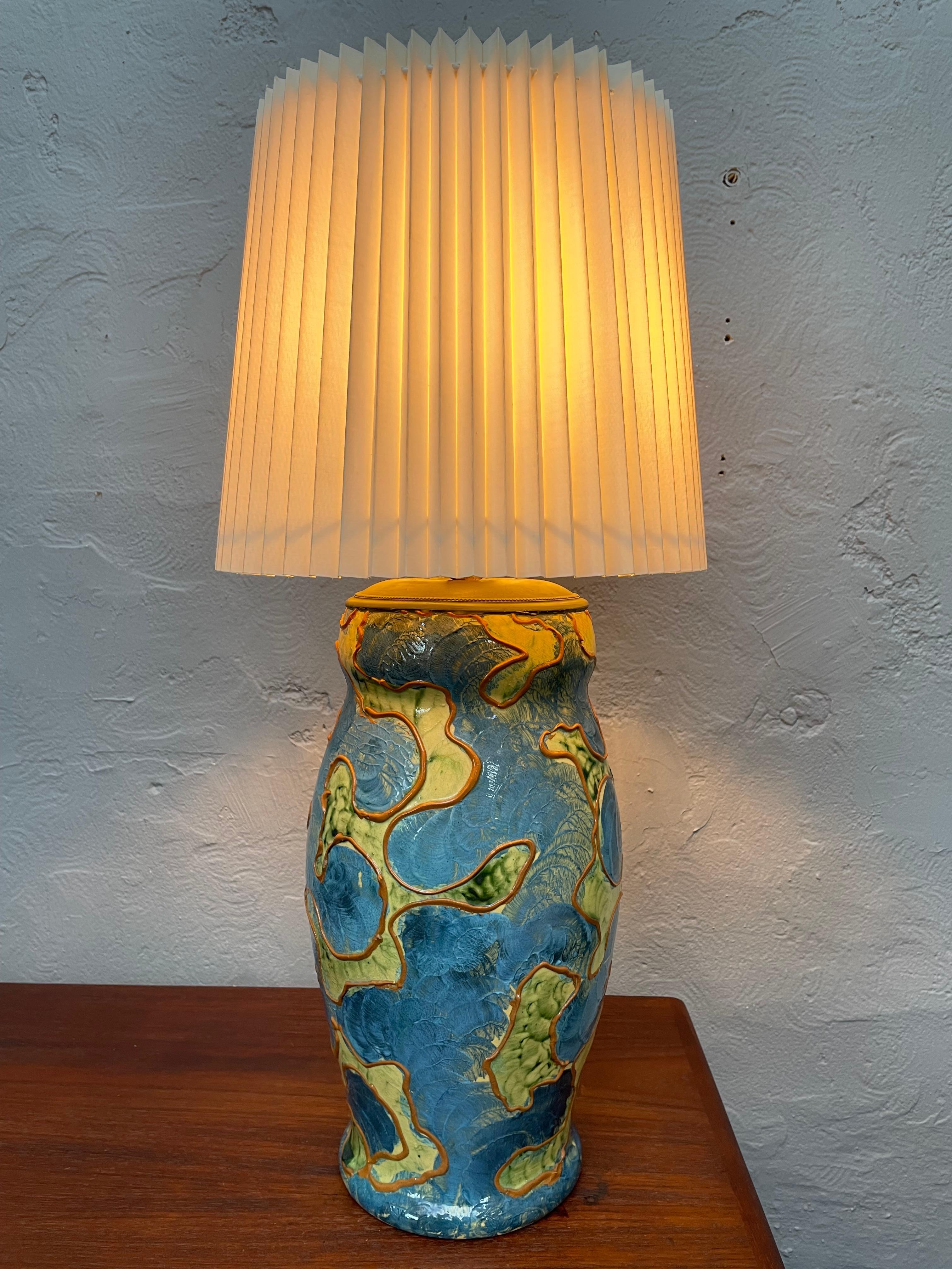 Antique and rare painted pottery vase table lamp made by Michael Andersen & Son of Bornholm
Designed by Daniel Andersen for the camouflage series.
With a beautiful blue and yellow glaze with slight shades of green.
Age related wear and with an age