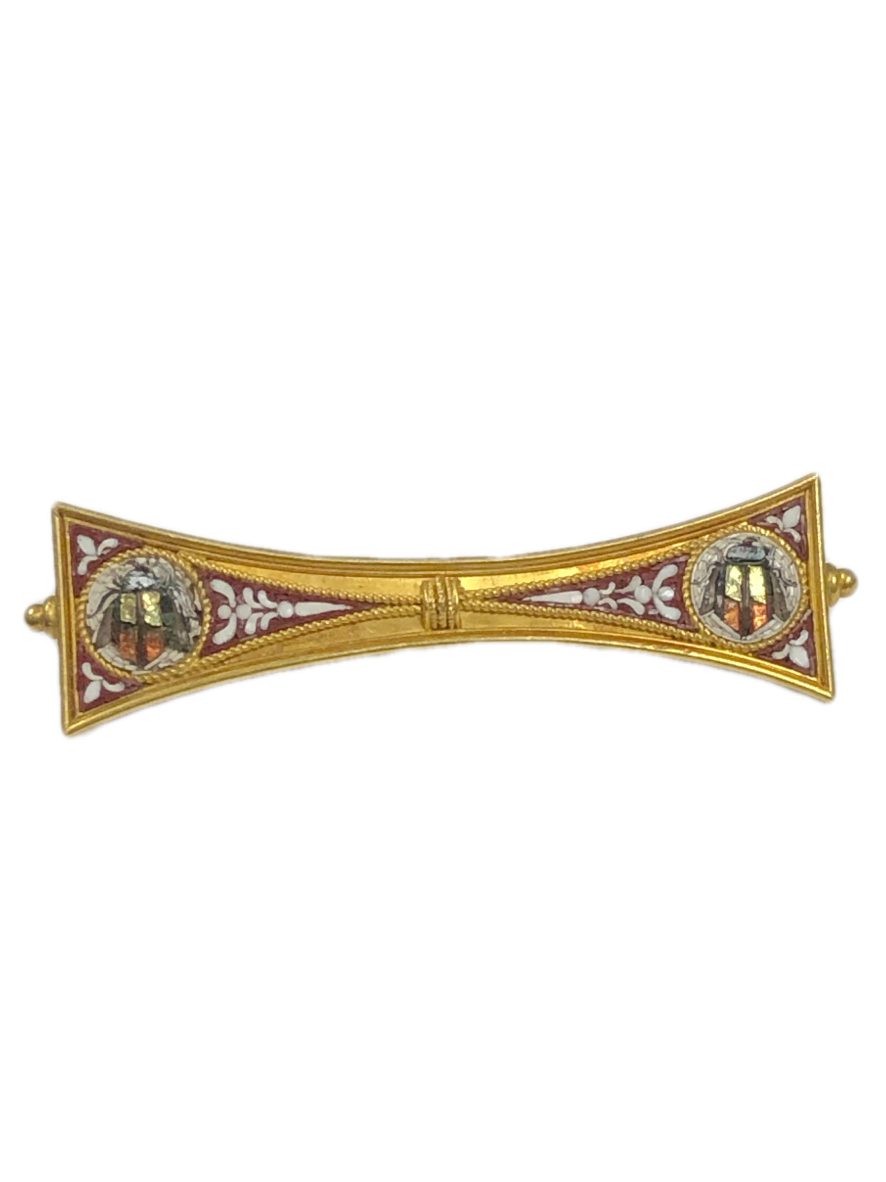 Circa 1890 14K Yellow Gold Micro Mosaic, Etruscan Revival Brooch, Measuring 2 1/8 inches in length and 9/16 inch wide, masterfully set with Glass Mosaic pieces forming winged Beatles a typical theme of these types of pieces also have fine wire and