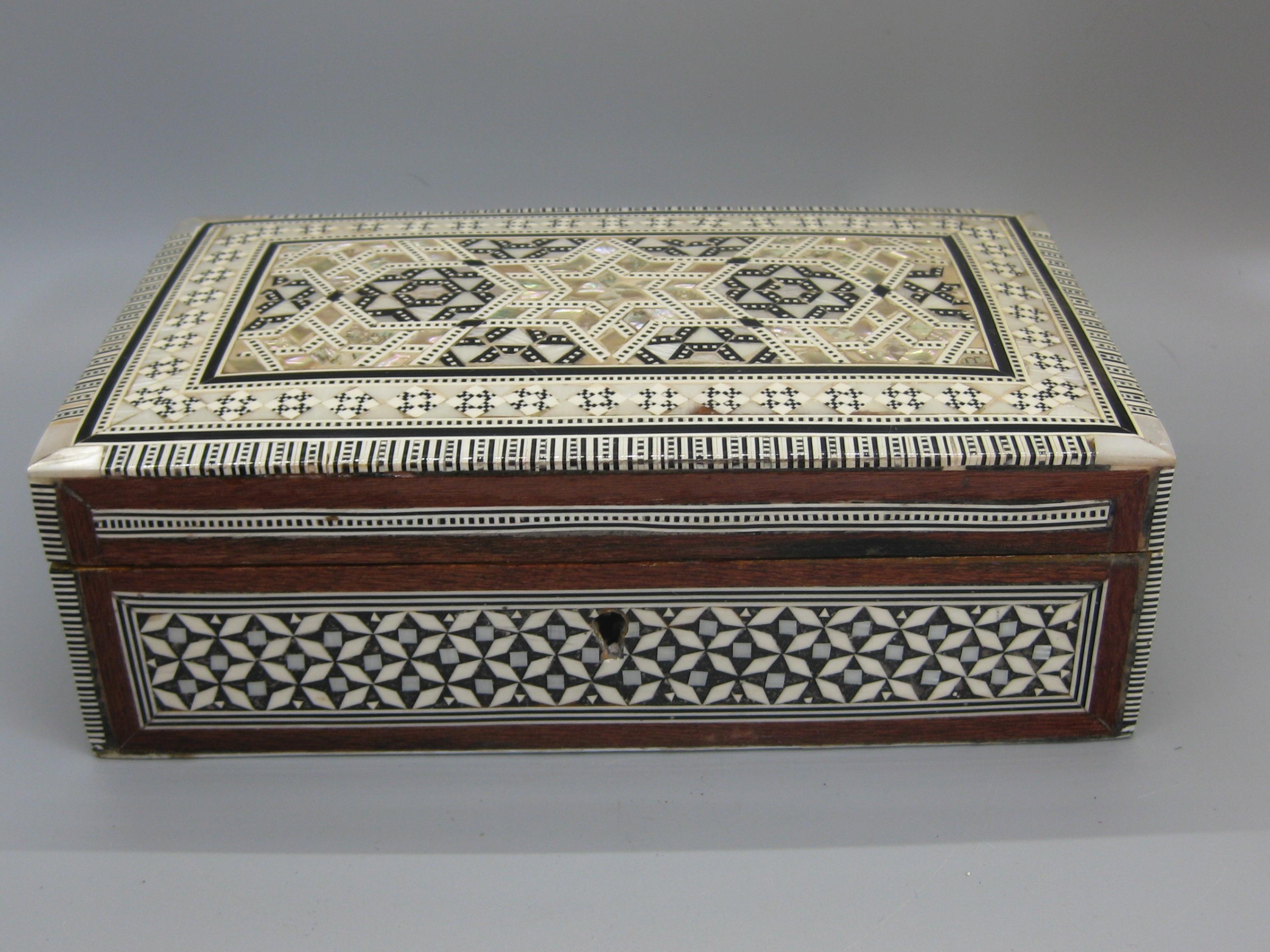 Beautiful highly detailed handcrafted micro mosaic marquetry wooden trinket/jewelry box. Pieces are made of mother of pearl and bone. High quality wood work and made very well. Inside is lined with red velvet. Measures approx. 7 3/4