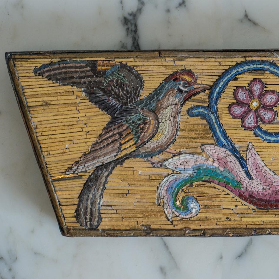 This beautiful antique multi-colored and gold leaf Micro Mosaic plaque is a rare one of a kind Maison Nurita find. The amount of detail and artistry is what makes this piece so astonishing. Ornate bird and flower motifs are delicately inlaid in a