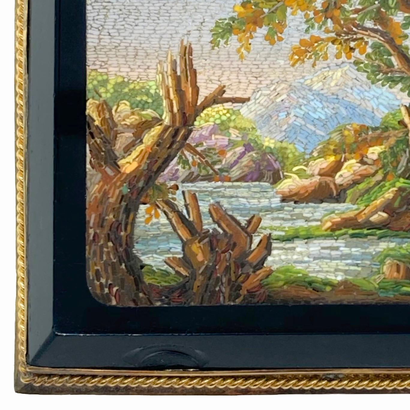 Micromosaic brooch depicting a landscape, with a river flowing through trees and around rocks, a mountain in the far distance, on rectangular black glass plaque. Rome, Circa 1830.