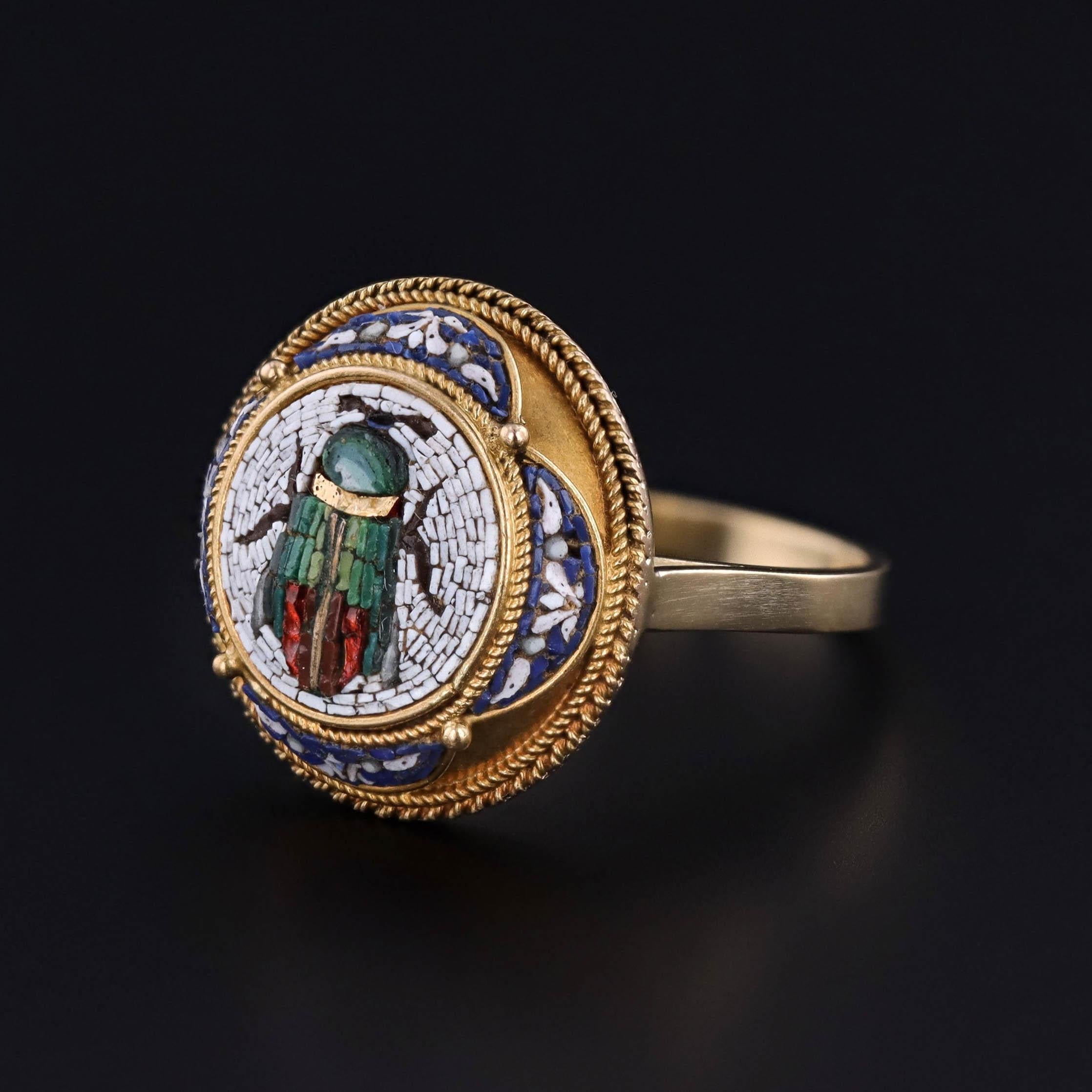 A statement ring created from a Victorian era button (circa 1870) 

The face of the ring features intricate micro-mosaic work depicting a scarab beetle, surrounded by a detailed border.  Our jeweler mounted the fine antique button onto a custom 18k