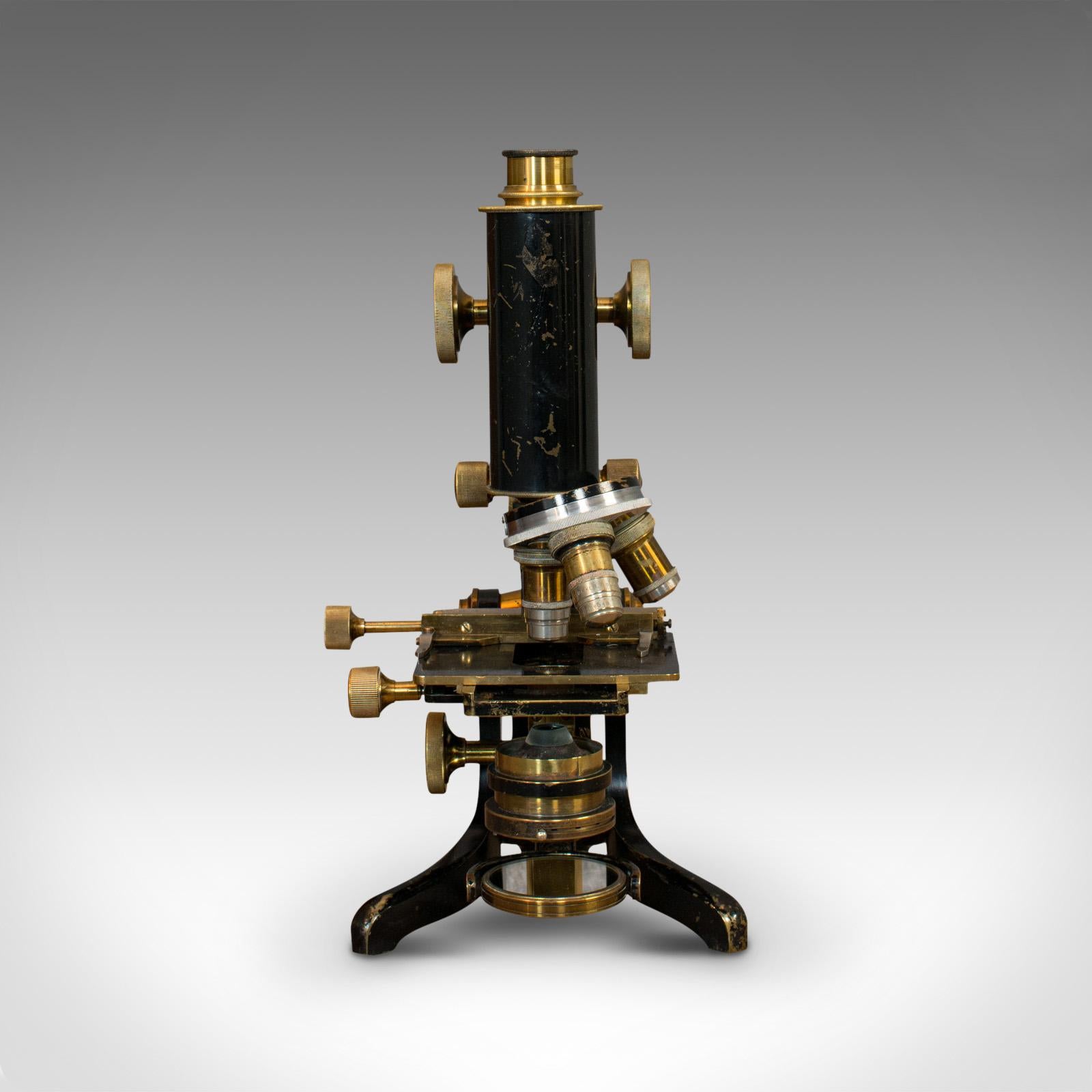 This is an antique microscope. An English, brass jug handle scientific instrument by C. Baker of London, dating to the Edwardian period, circa 1910.

Attractive and appealing scientific instrument
Displays a desirable aged patina
Lacquered brass