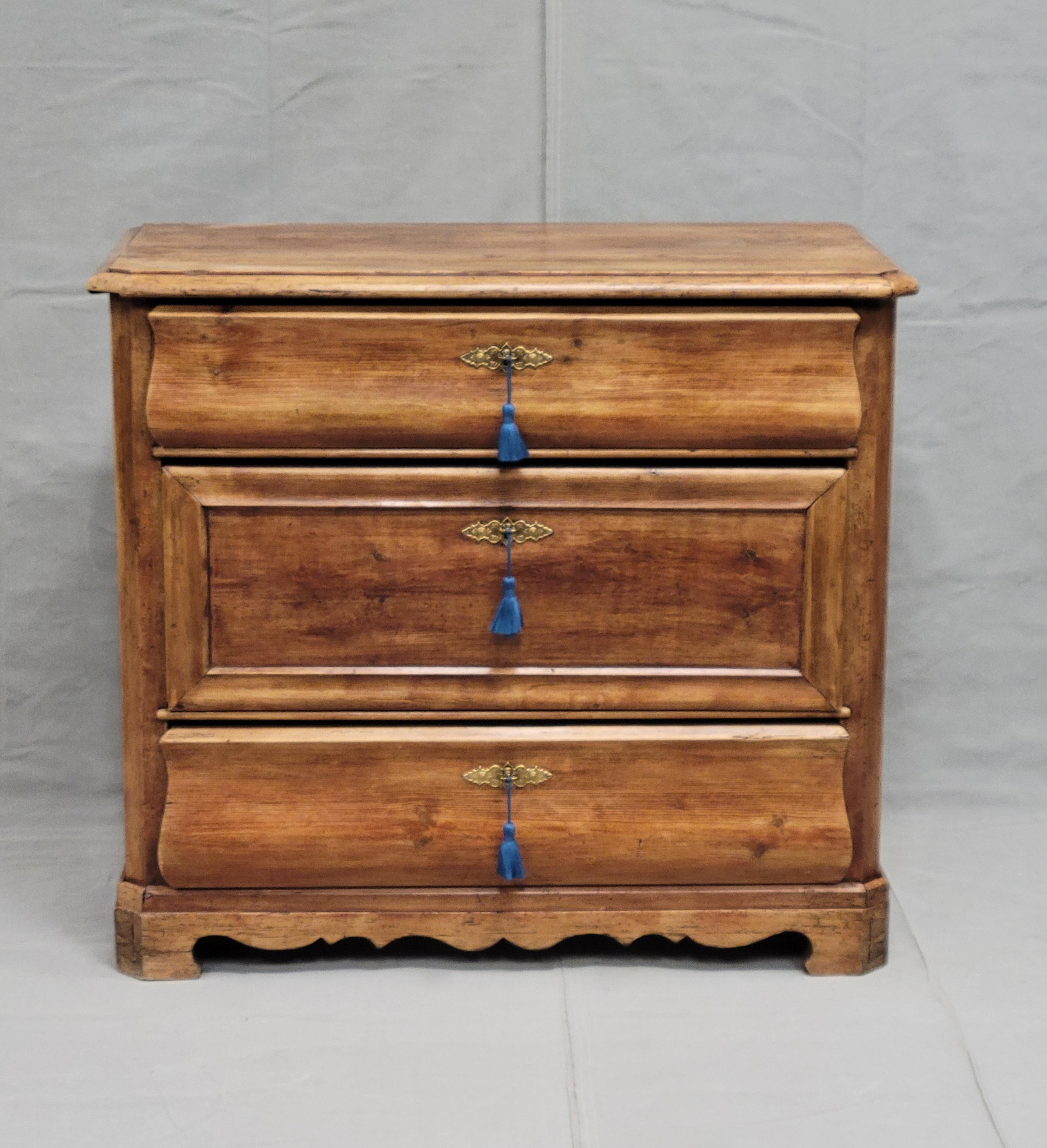 This beautiful Swedish or Danish antique chest of drawers was beautifully crafted out of pine in the early or mid-1800s. Note the beautiful and expert 45 degree angle wood joinery at the top and base corners, as well as dovetails on the drawers. The