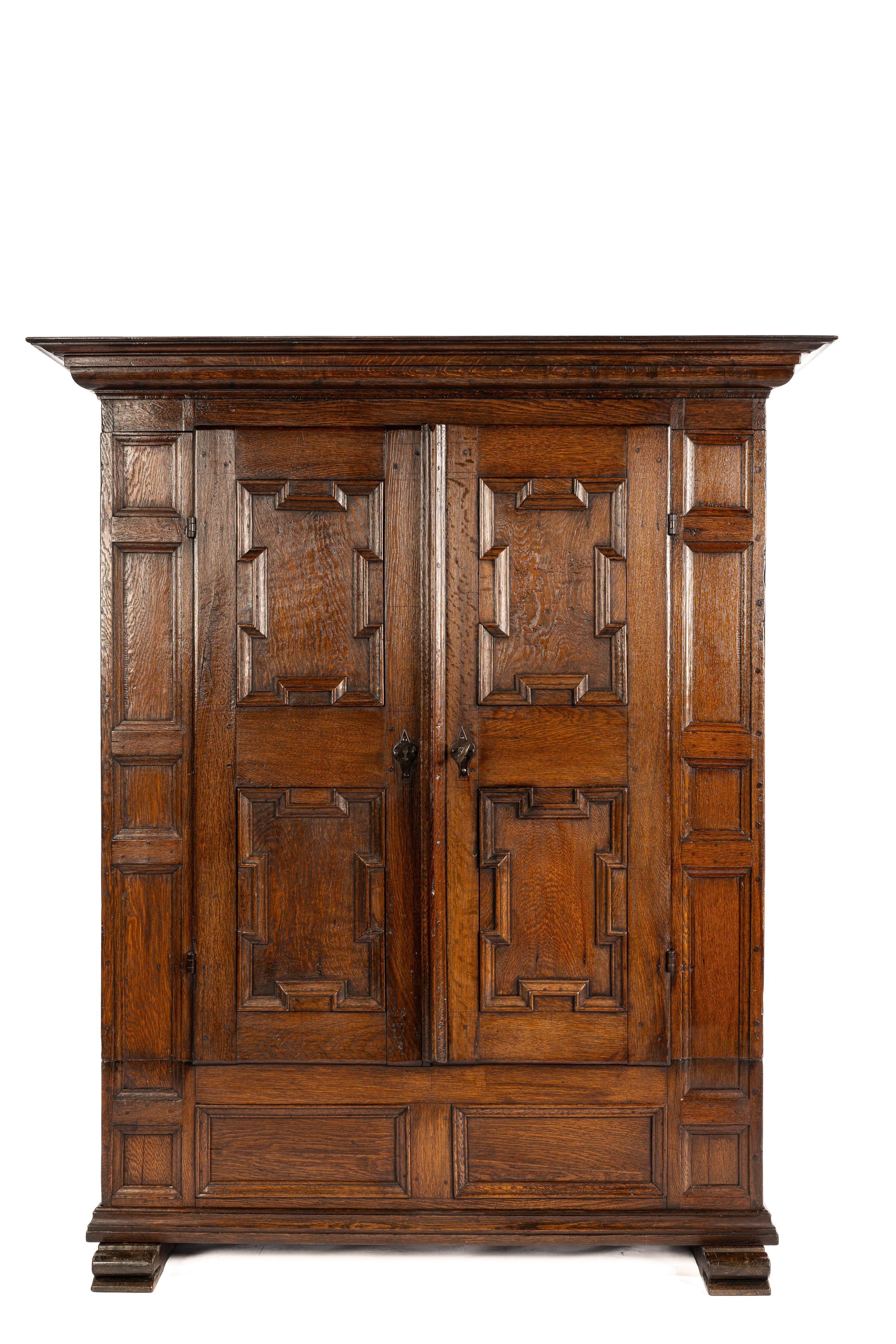 This stunning antique cabinet was crafted in the mid-18th century, around 1750, in the Westphalia region of Germany. Made entirely from the finest quality European summer oak, carefully selected for its beautiful grain pattern, the wood panels