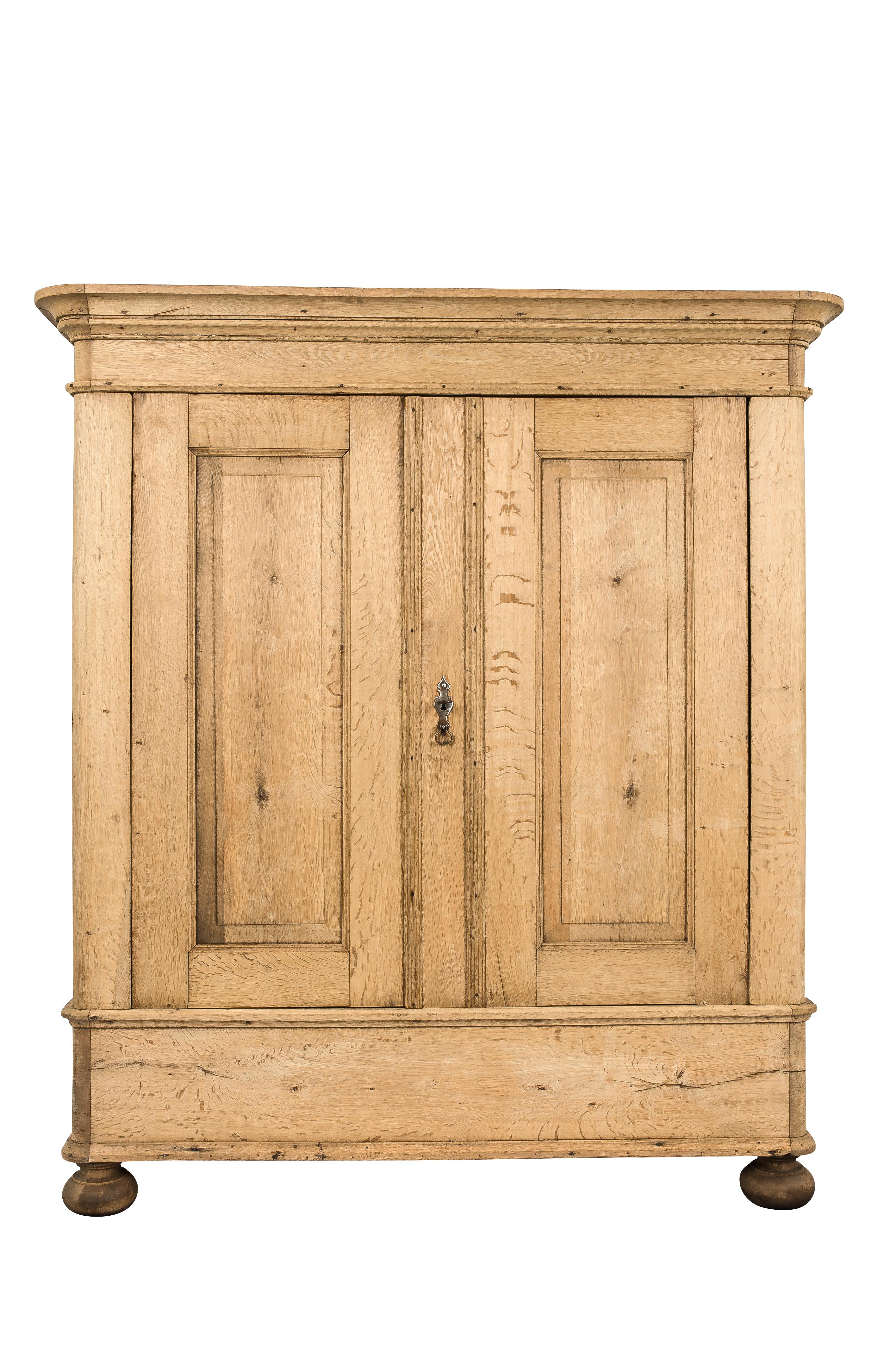 A rustic two-door cabinet that was made in Germany in the mid-19th century. It has beautifully rounded corners that give a natural touch to the piece. Both doors and sides are fitted with elevated panels surrounded by an elegant mold. It was