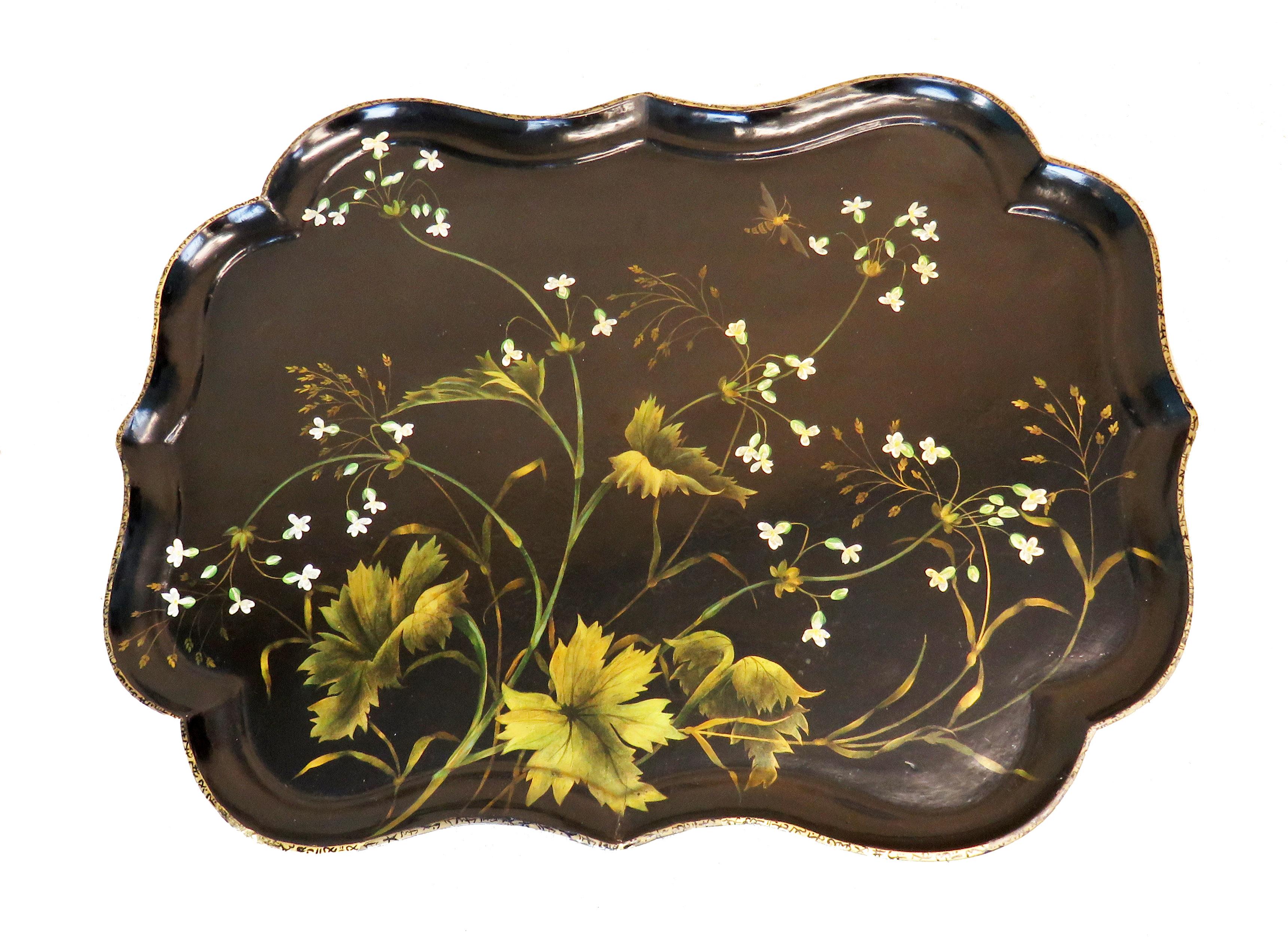 A very attractive mid-19th century papier mache tray having
shaped sides and hand painted decoration raised on
later faux bamboo stand

(What better way to look after the environment than to 
recycle beautiful, old, antique objects with little