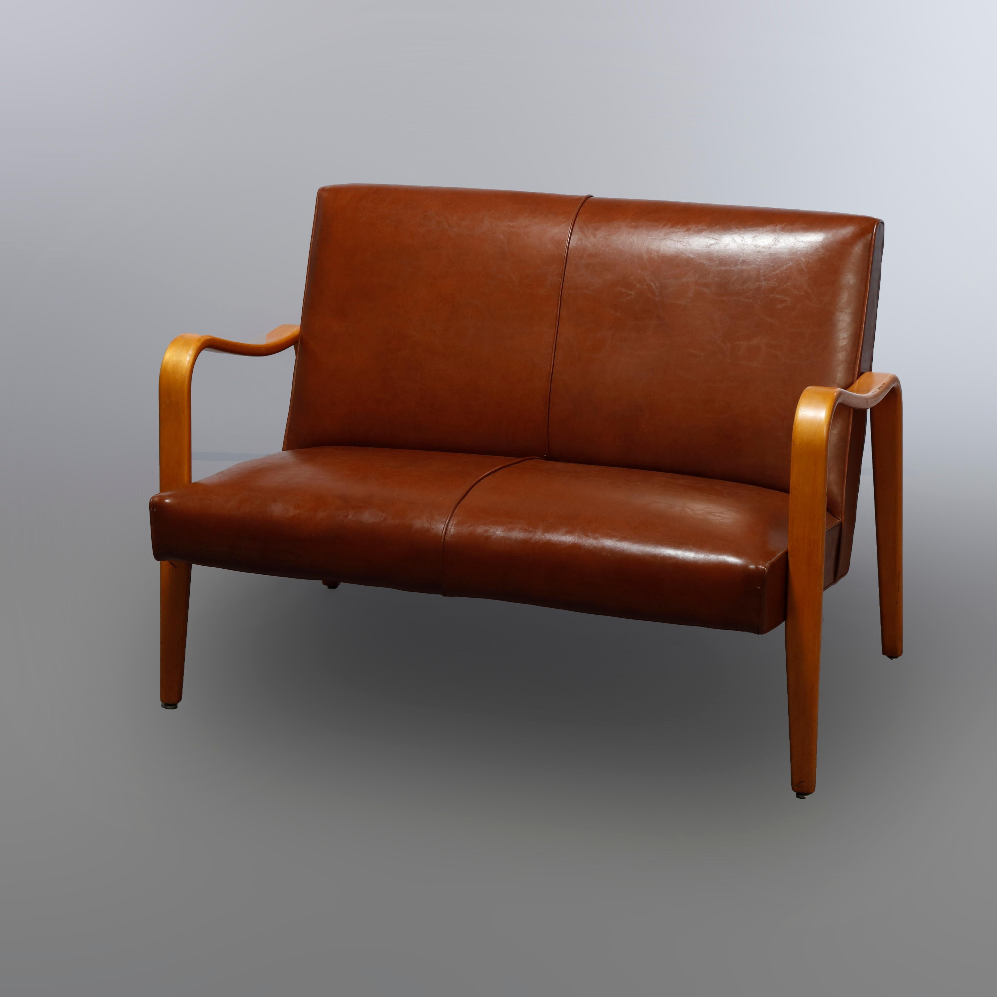 A Mid-Century Modern pair of settees by Thonet offers bent wood laminated frame with leather backs and seats, label as photographed, 20th century

Measures: 32
