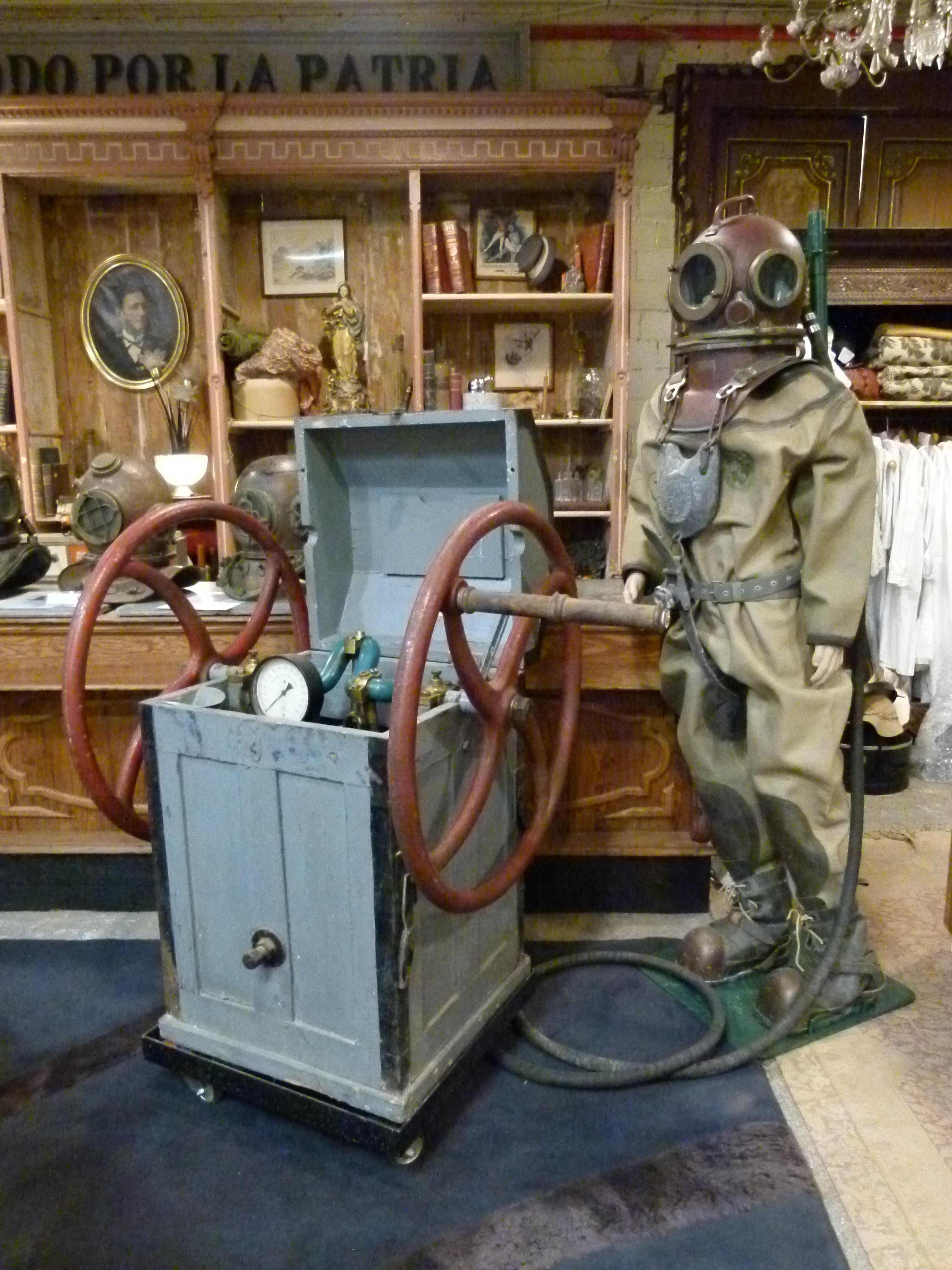Antique midcentury Russian dive equipment that includes:
Three Bolt Diving Helmet. Civil model. 3B UVS-50
Corselet
Diving dress
Diving knife
Weighted shoes
Manual pump
Mannequin, mannequin stand and pump car.



 