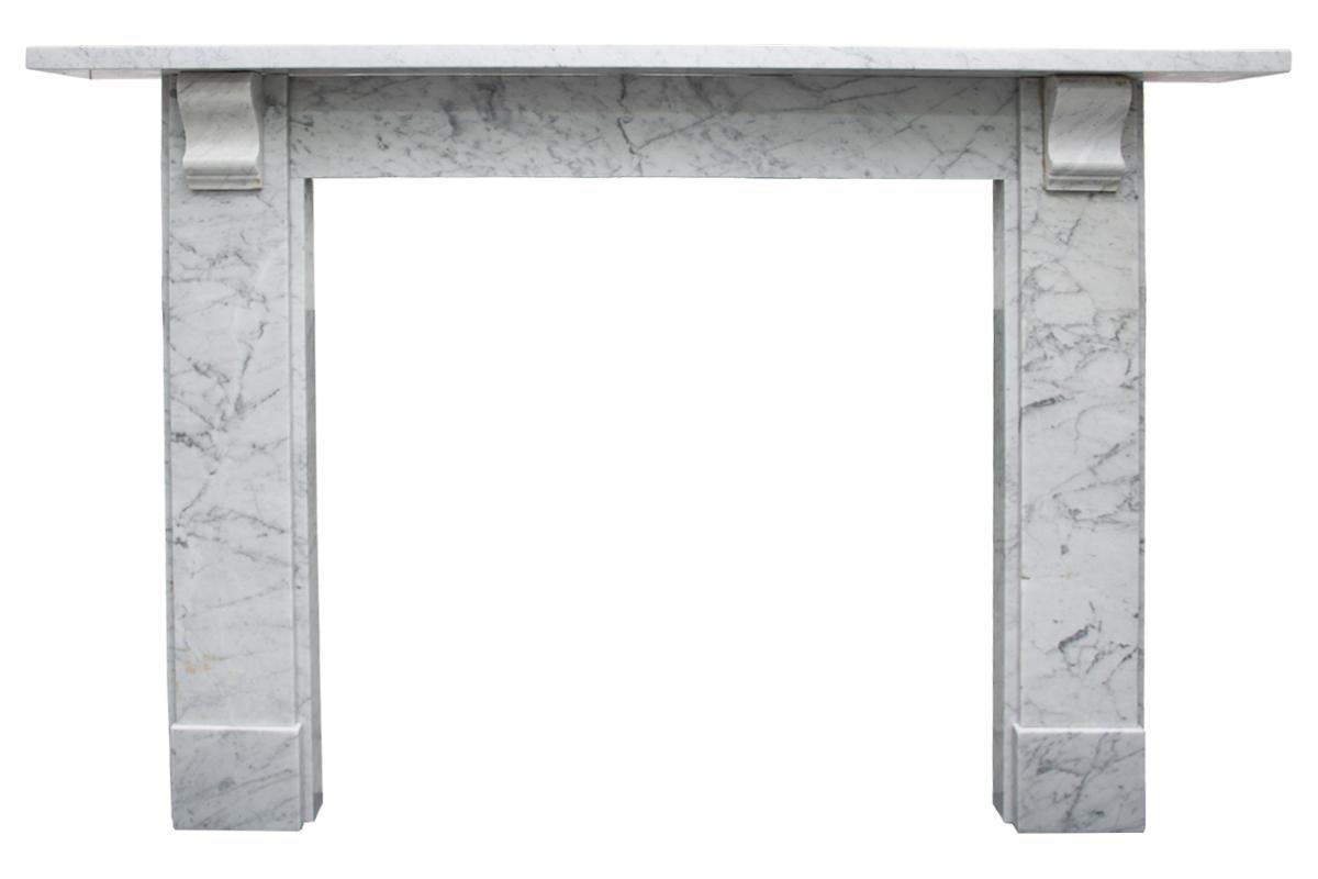 Antique mid Victorian Carrara marble fireplace surround with a simple corbels supporting the shelf. 

 