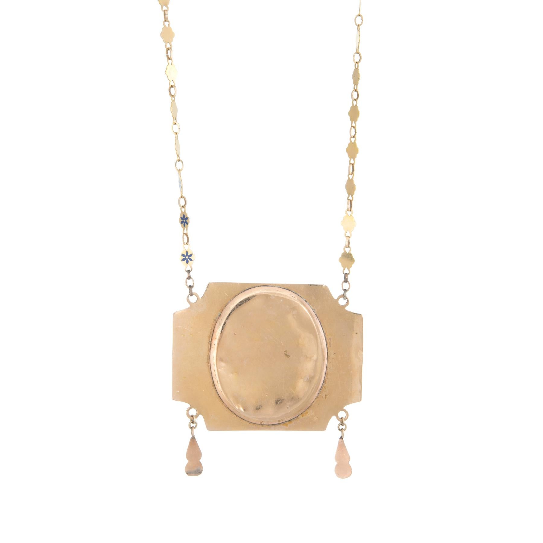 Finely detailed antique mid Victorian cameo necklace crafted in 14 karat yellow gold (circa 1860s to 1870s). 

The beautifully detailed necklace highlights a large, enameled portrait cameo of a woman. Surrounding the cameo is scrolled foliate detail