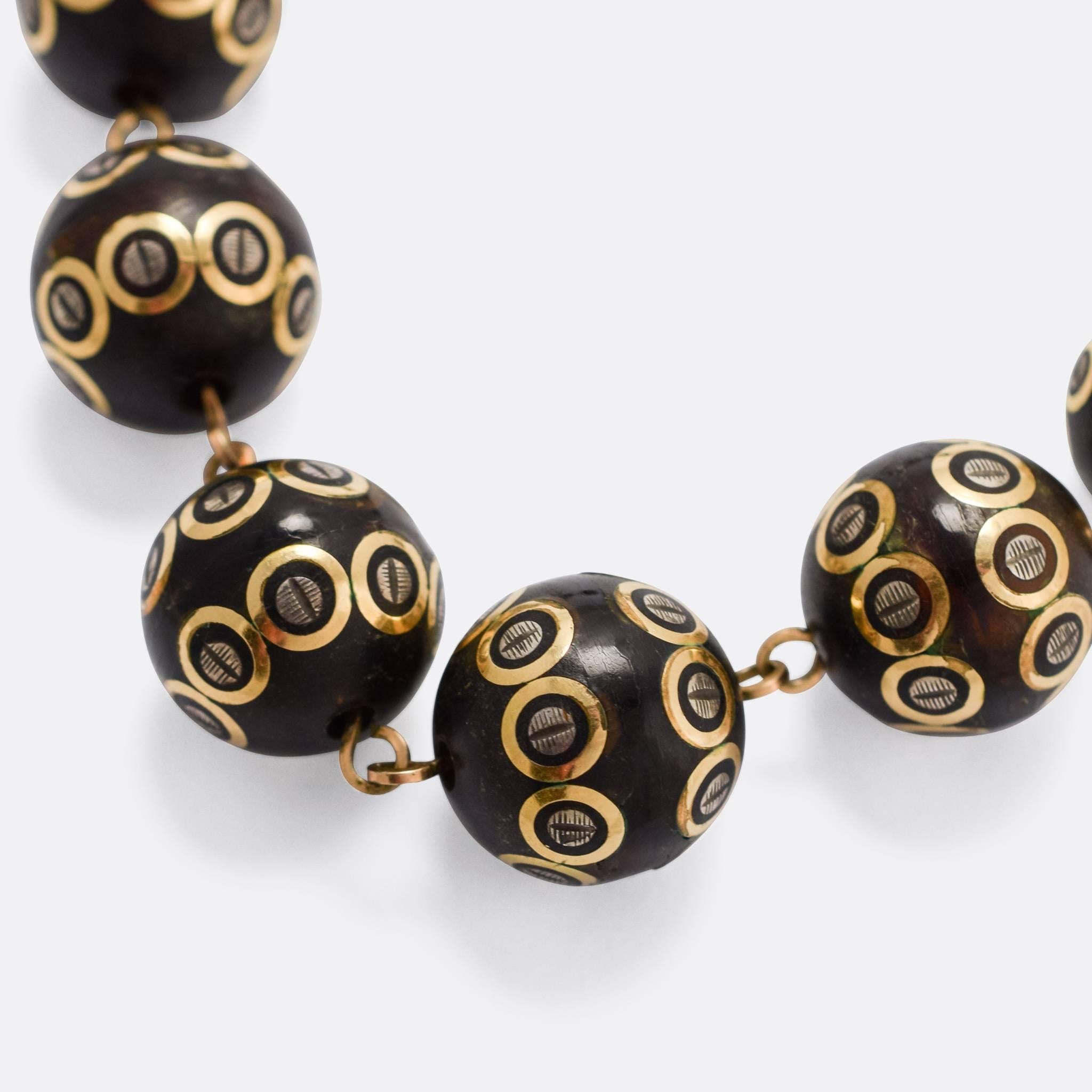 A most unusual, Museum Quality, Victorian graduated bead necklace - dating to c.1860. The beads are made from pique, a term used to describe the process of inlaying precious metal in moulded tortoise shell to create a pattern. The piece comprises 24