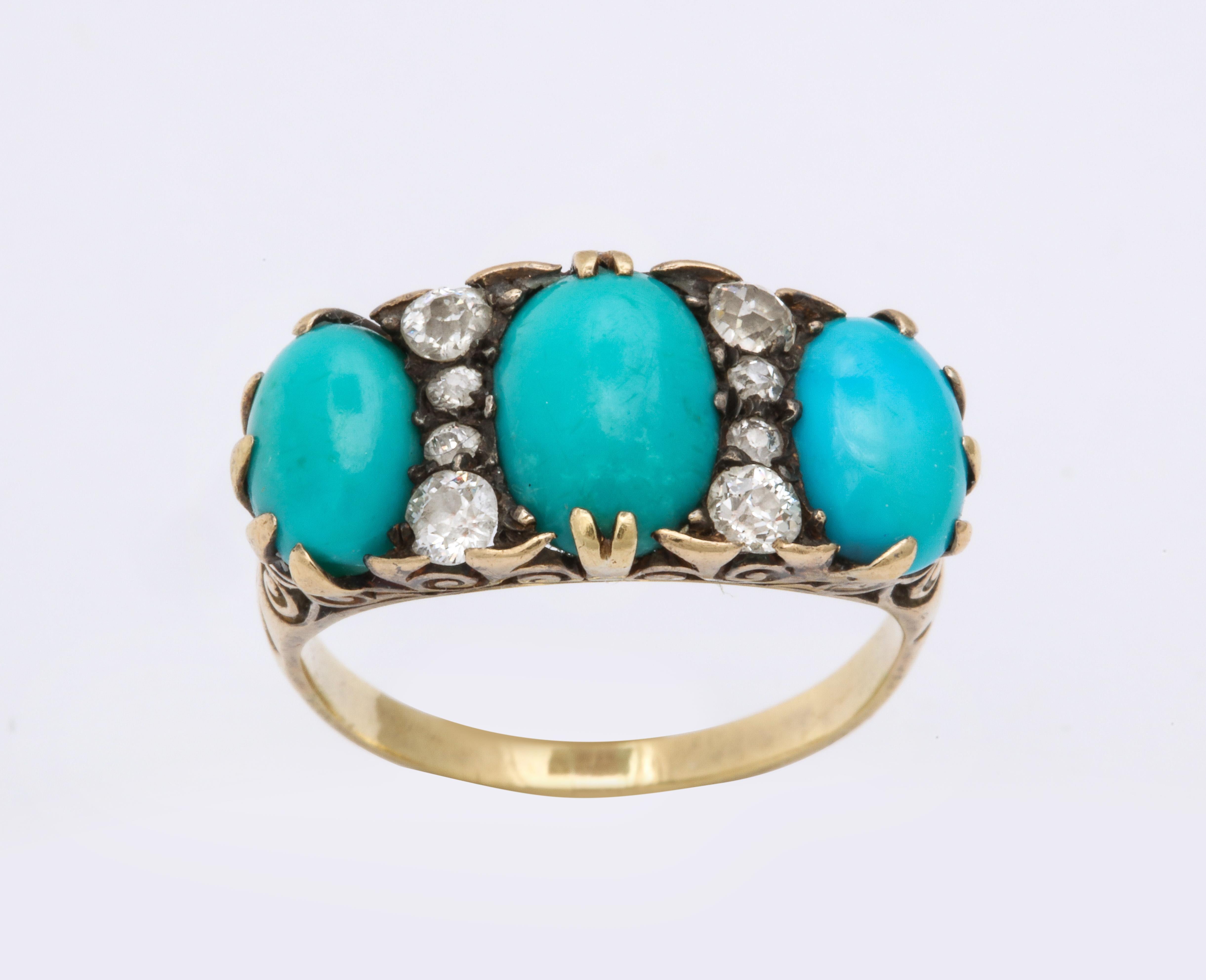Three sky blue, oval turquoise gems are separated by eight diamonds set in a stunning 18 Kt ring made c.1860 in one original piece, The shoulders are tulips with strong triangular prongs holding stones of approximately 13mm and 10mm. Added for
