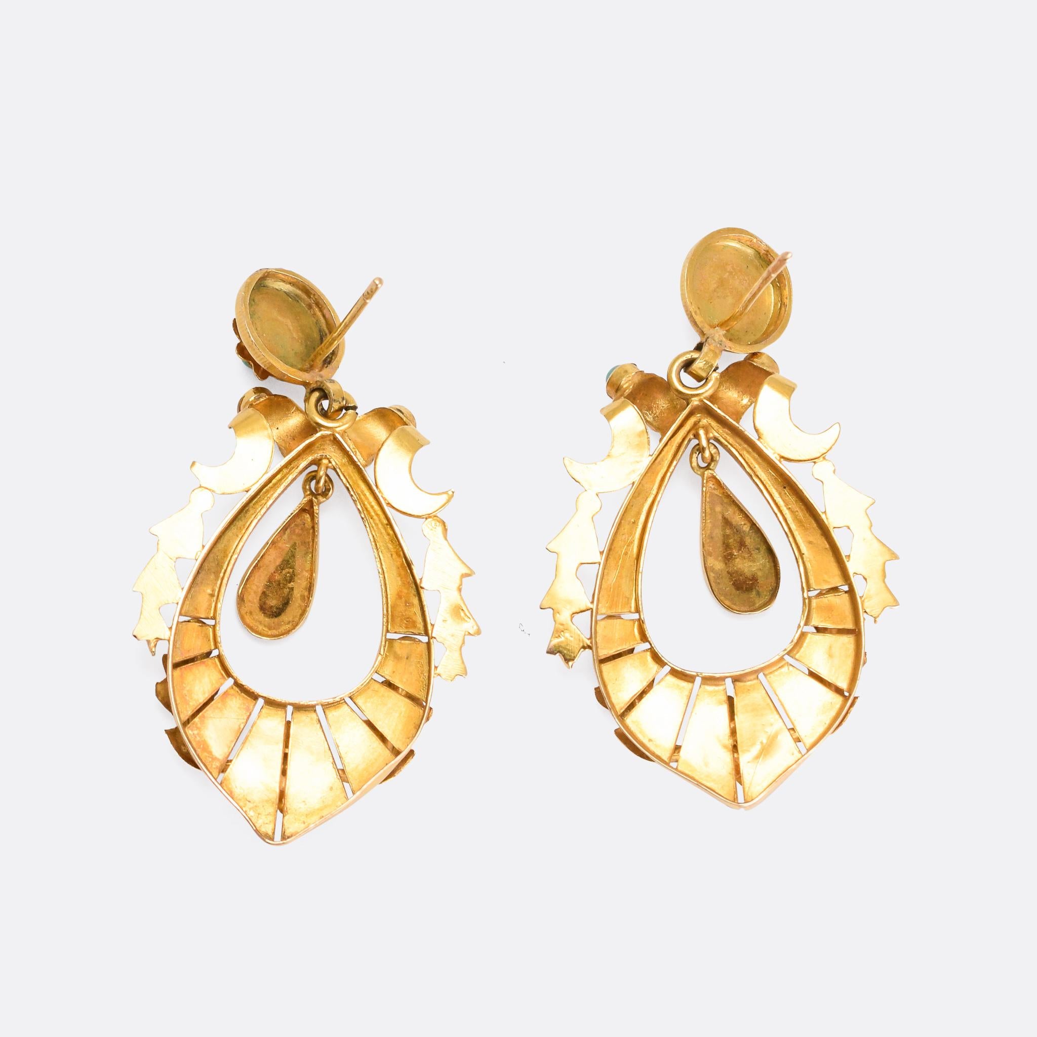 An exceptional pair of antique earrings dating from the mid-Victorian era, circa 1860. They're modelled in 15 karat gold and set with turquoise cabochons; featuring crescent moon, star, and oak leaf motifs, along with further foliate style