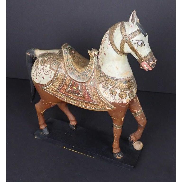 Antique Middle Eastern carved and paint decorated sculpture of a horse. Fine quality polychrome and gilt carved wood temple horse. The piece dates back to the late 19th century.
