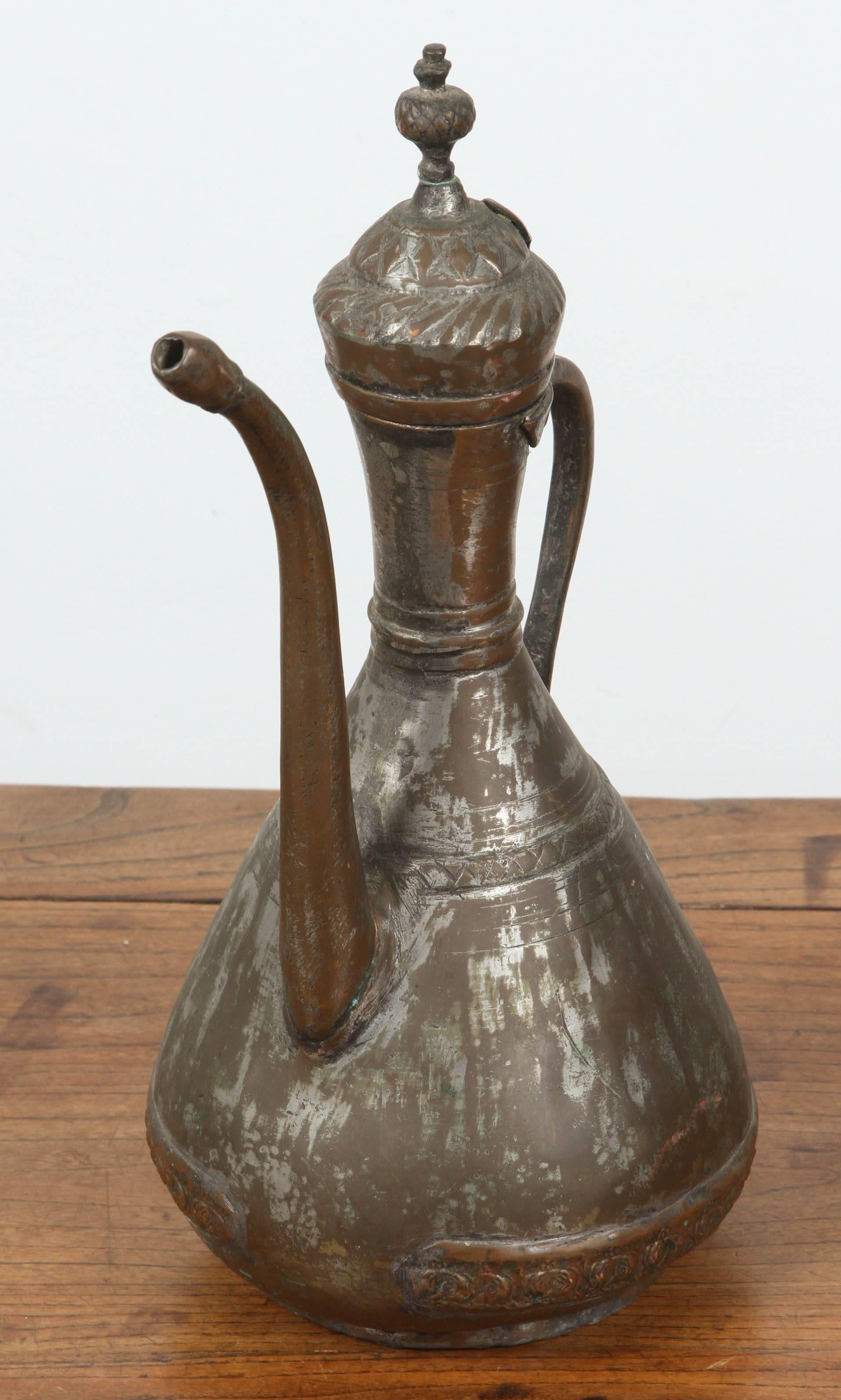 Antique Middle Eastern Turkish or Persian tinned copper ewer.
Nice decorative hand-hammered vessel, great antique patina.
Handcrafted Asian coffee pot or tea pot, tinned copper, great ethnic metalwork typical from the Middle East Moorish style.
