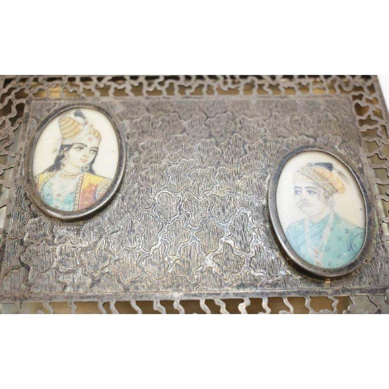 Antique Middle Eastern Sterling Silver Pierced Potpourri Box, Mini Portraits

A pierced sterling silver table potpourri box, with two finely painted miniatures raised and framed hand painted portraits a man and woman. Marked sterling silver along