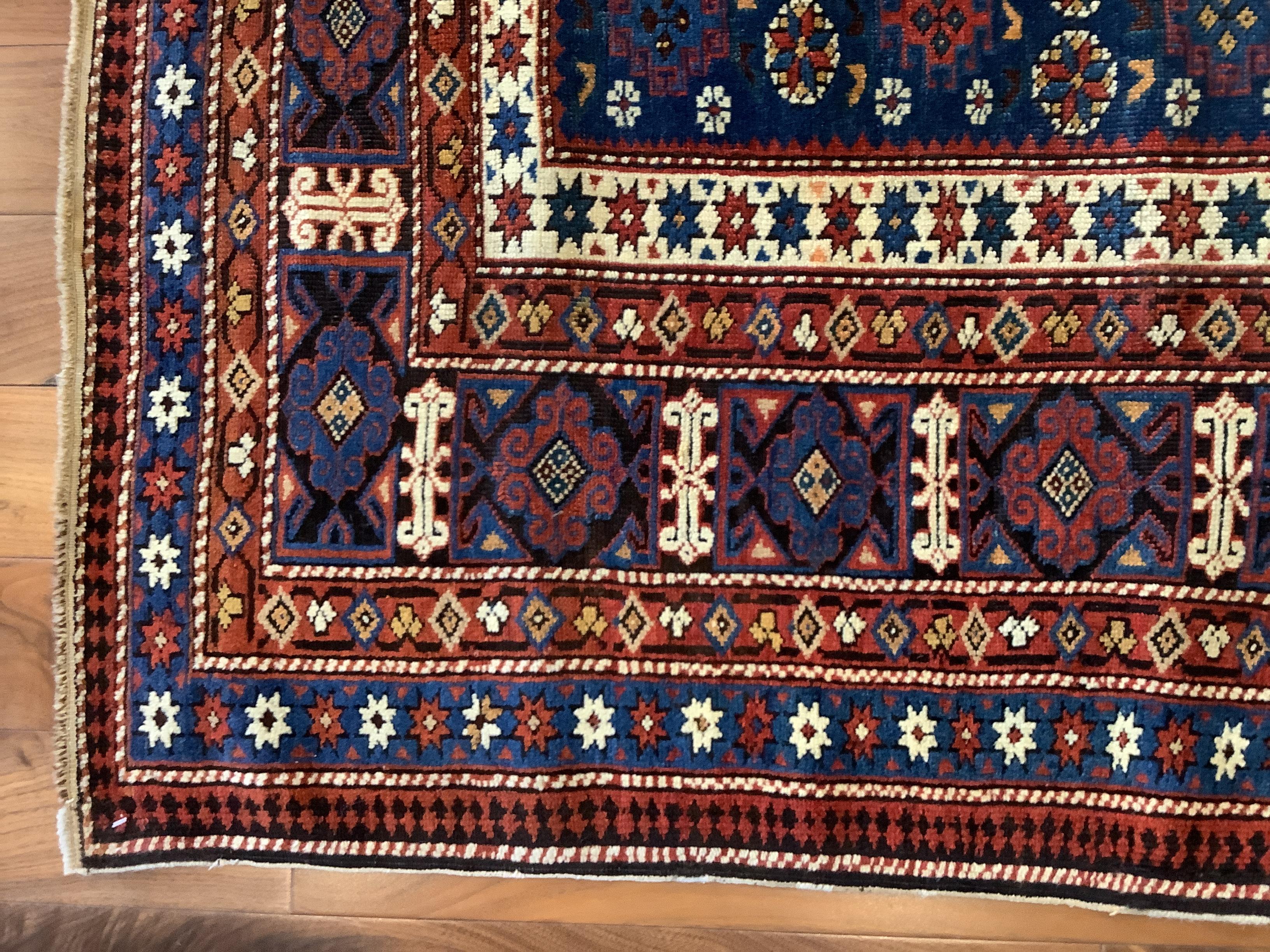 Chi Chi rugs, with their rich variety of small-format geometric motifs which hermetically cover the field and borders, are considered some of the most elaborate Caucasian weavings. The midnight blue field of this piece is filled with an immaculately