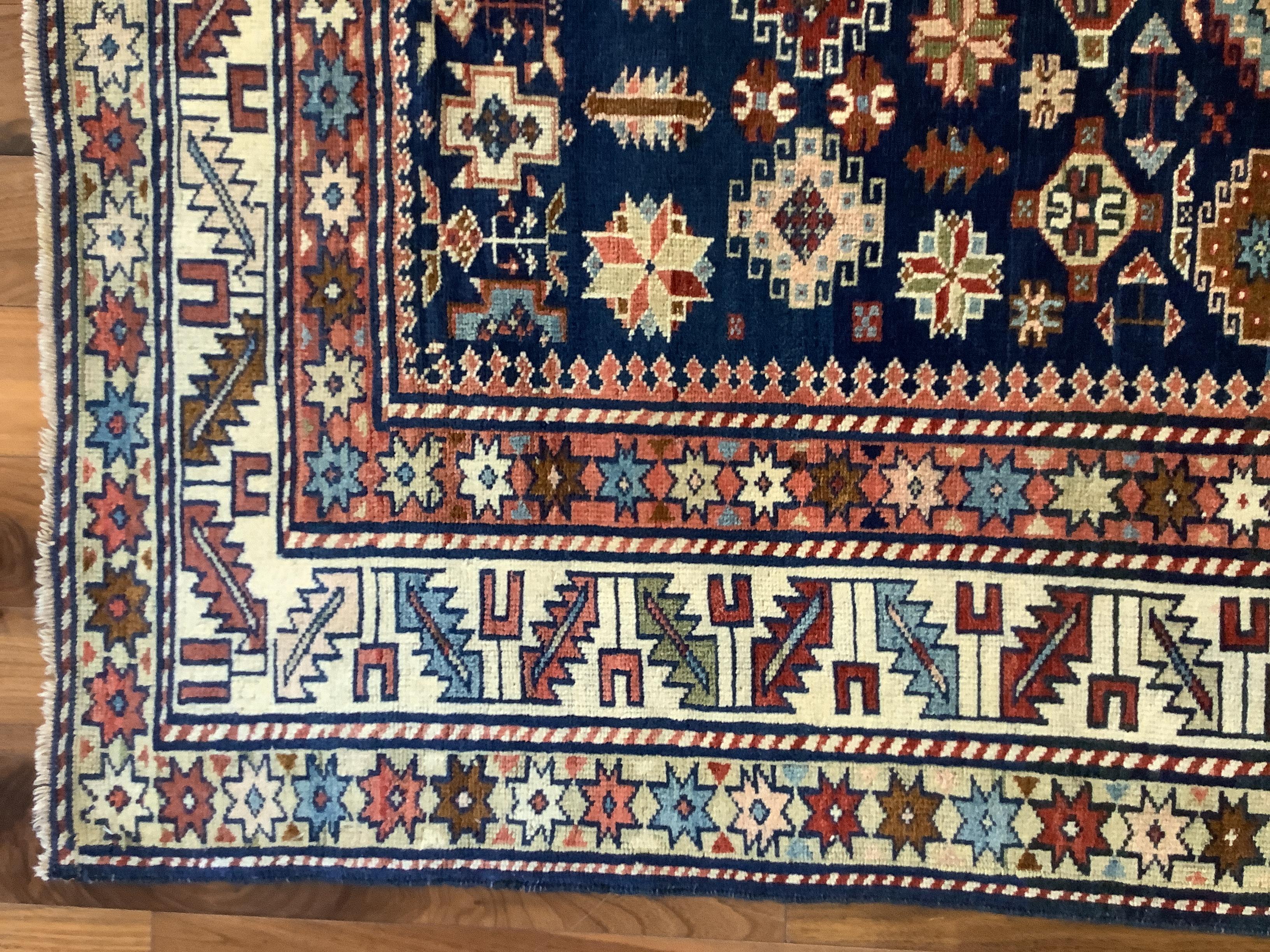 Chi Chi rugs, with their rich variety of small-format geometric motifs which hermetically cover the field and borders, are considered some of the most elaborate Caucasian weavings. The midnight blue field of this piece, with a beautiful Abrash color