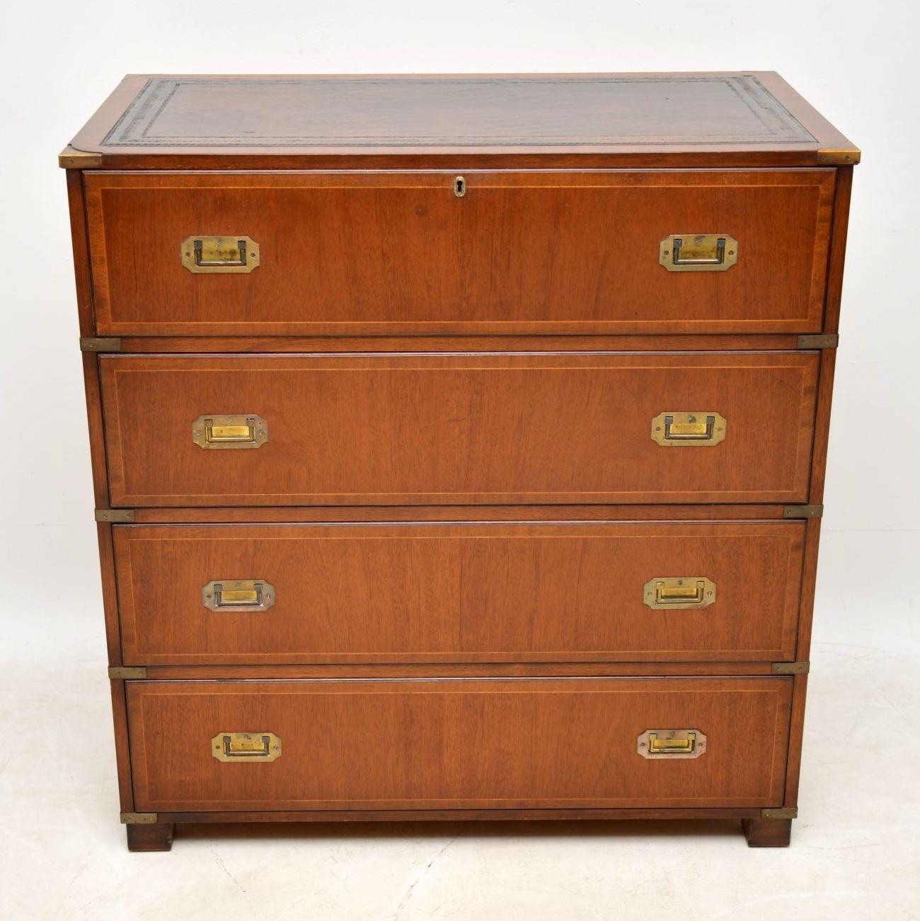 Right now there are a matching pair of bedside chests on the site to go with this piece and they would all go well together in the same room. This mahogany secretaire chest of drawers is antique military style and dates from around the 1950s period.