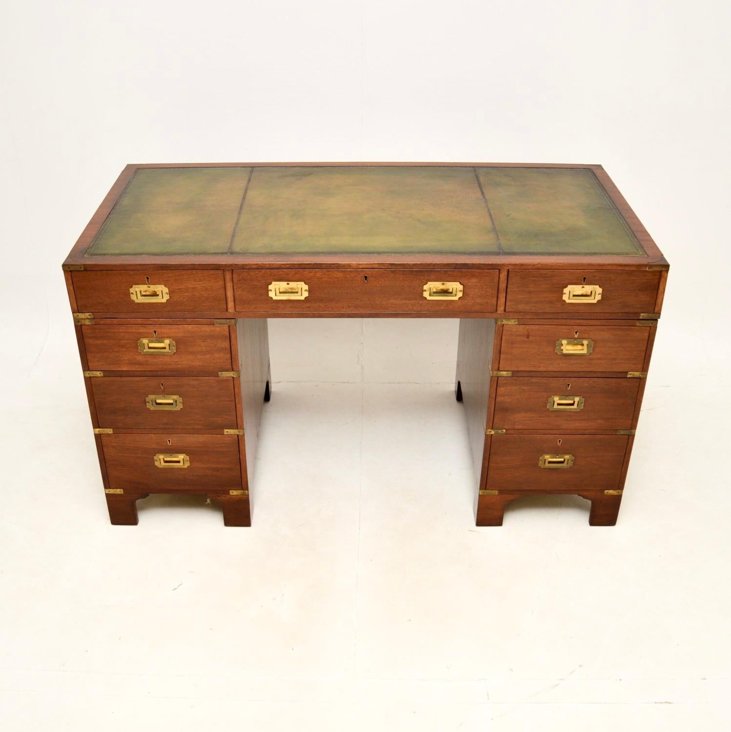 A top quality antique military campaign style desk. This was made in England, it dates from around the 1930’s.

It is very well made, with a useful and smart design. The wood has a lovely colour tone, there is high quality brass hardware throughout,