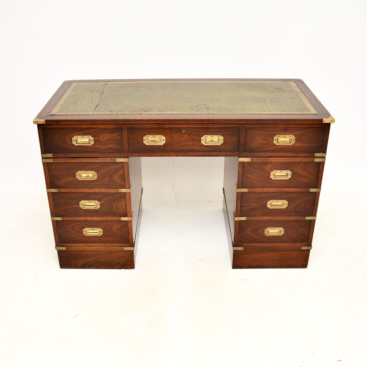 A top quality antique military campaign style desk. This was made in England, it dates from around the 1930’s.

It is very well made, with a useful and smart design. The wood has a lovely colour tone, there is high quality brass hardware throughout,