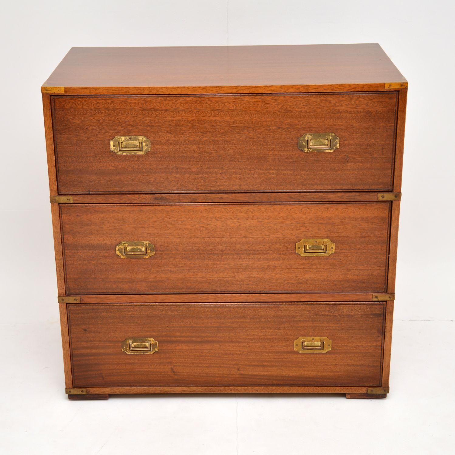 A handsome and useful antique military campaign style chest of drawers, this dates from around the 1930s-1950s.

This chest is a nice compact piece of furniture with deep drawers & plenty of storage. It’s mahogany with brass corner fittings, brass