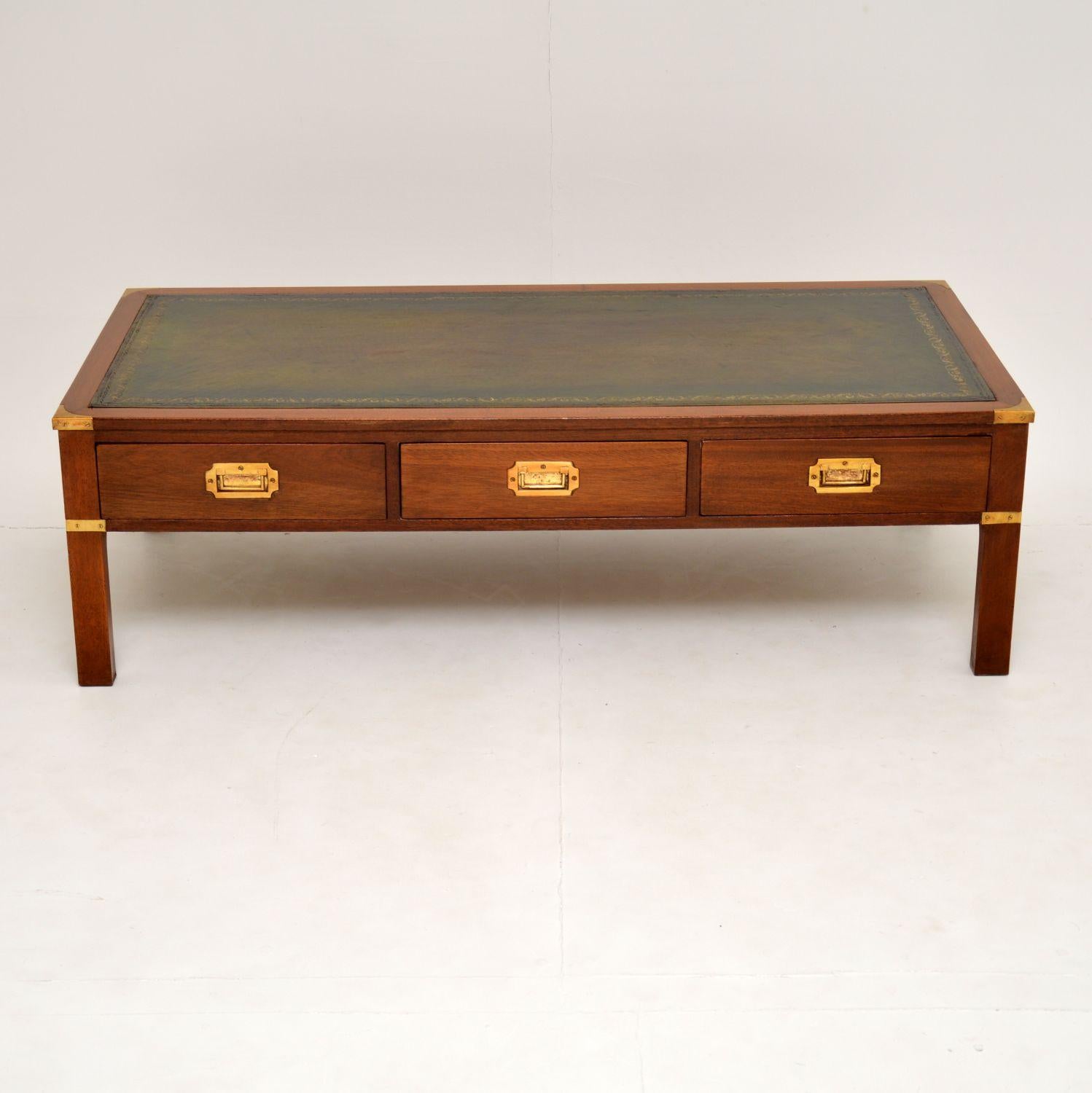 A smart and extremely well made coffee table in the antique military Campaign style. This is of great quality, its made from mahogany, with a leather top, brass corner fittings, a tooled leather top and three drawers with inset brass military