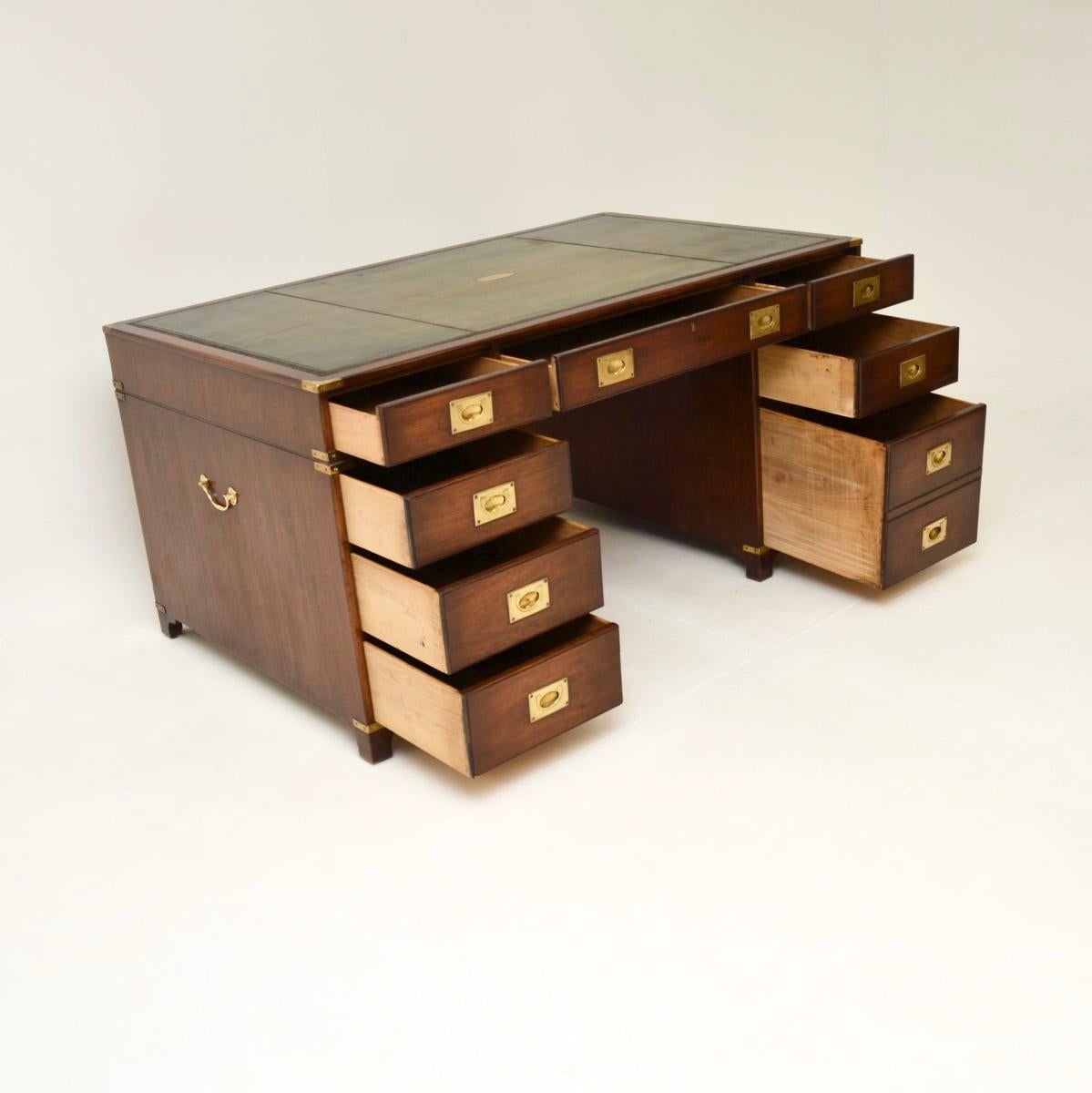 A fantastic antique military campaign style partners desk. This was made in England, it dates from around the 1930’s.

It is of outstanding quality, it is a large and useful size, with plenty of work space and storage space. The leather top has