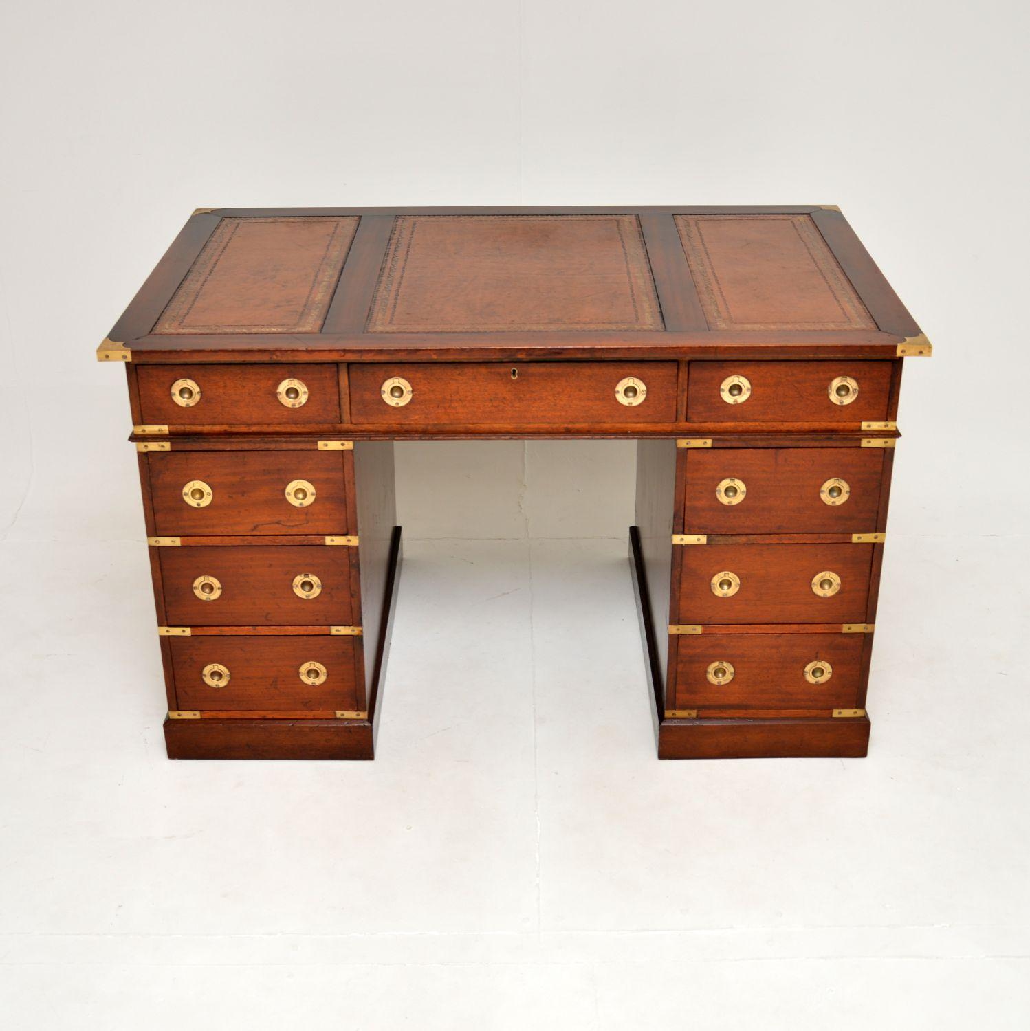 A fine antique military campaign style pedestal desk. This was made in England, it dates from around the 1950’s.

It is of fantastic quality, it is a very functional and beautifully designed item of furniture. The wood has a lovely patina, with