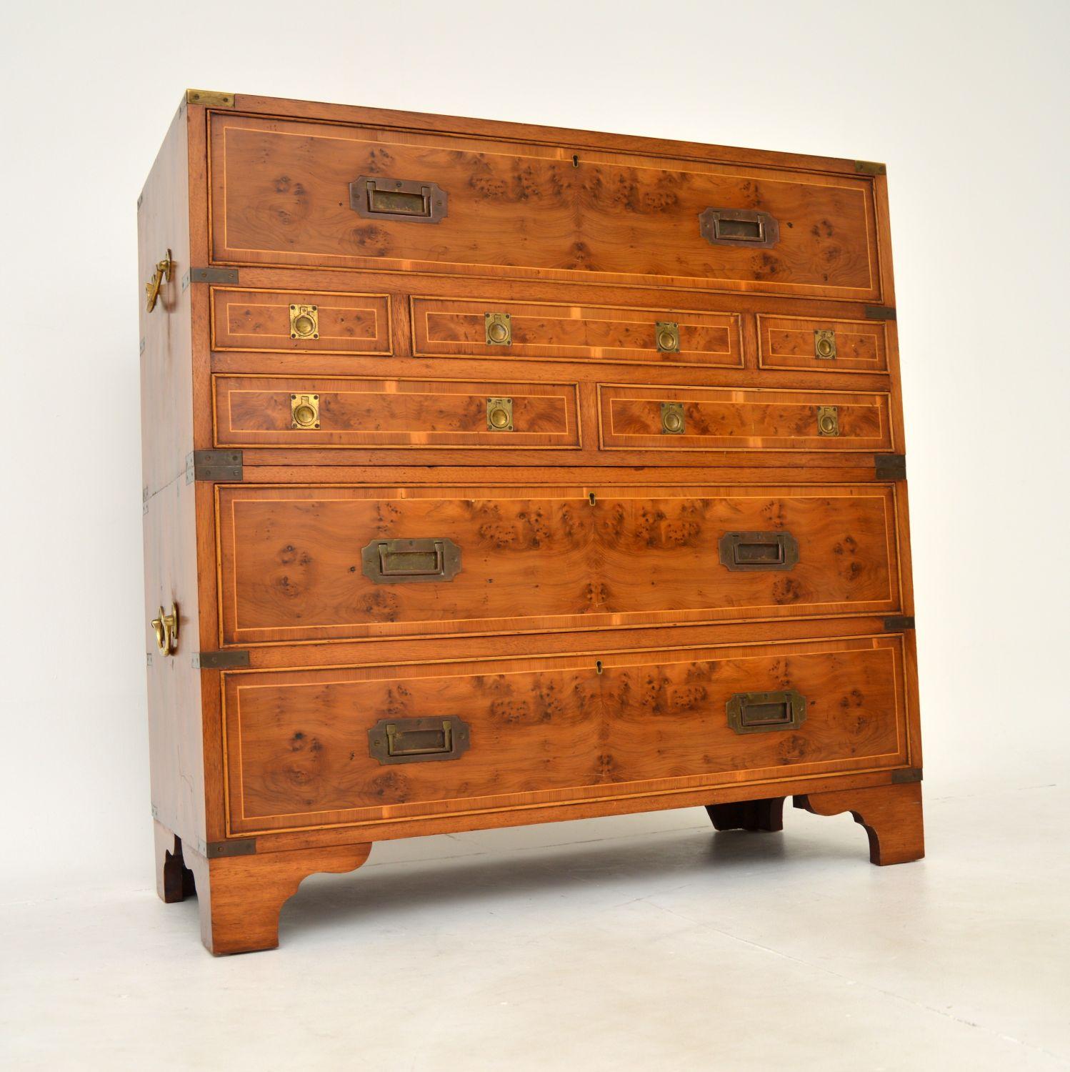 A superb antique military campaign style chest of drawers with a built in secretaire bureau. This was made in England, it dates from around the 1930’s.

The quality is absolutely amazing, this is a very smart and very useful item. The top drawer
