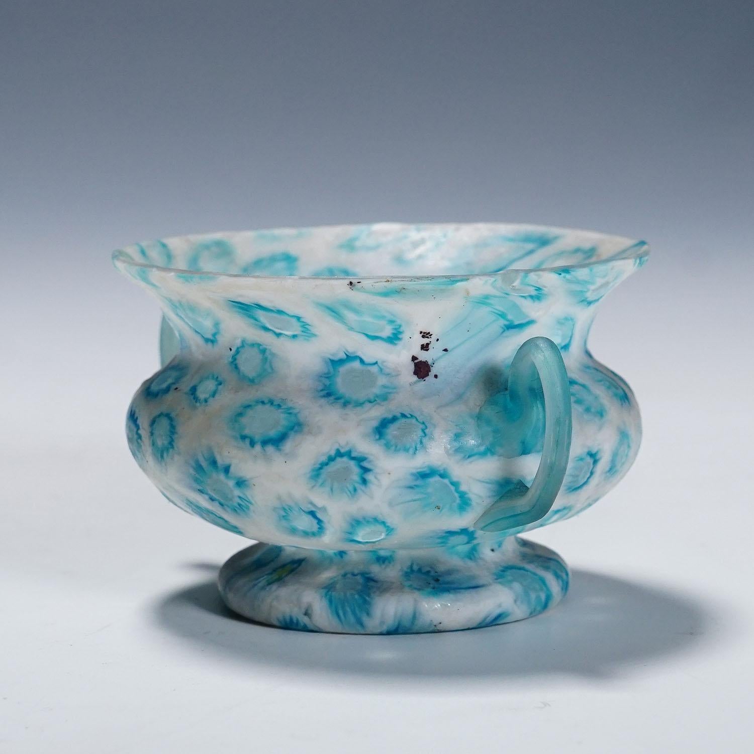 Antique Millefiori Bowl with Handles, Fratelli Toso Murano ca. 1920s

A small millefiori murrine glass bowl with two handles manufactured by Vetreria Fratelli Toso, Murano around 1900. Made of polychrome murrines in blue and white which are melted