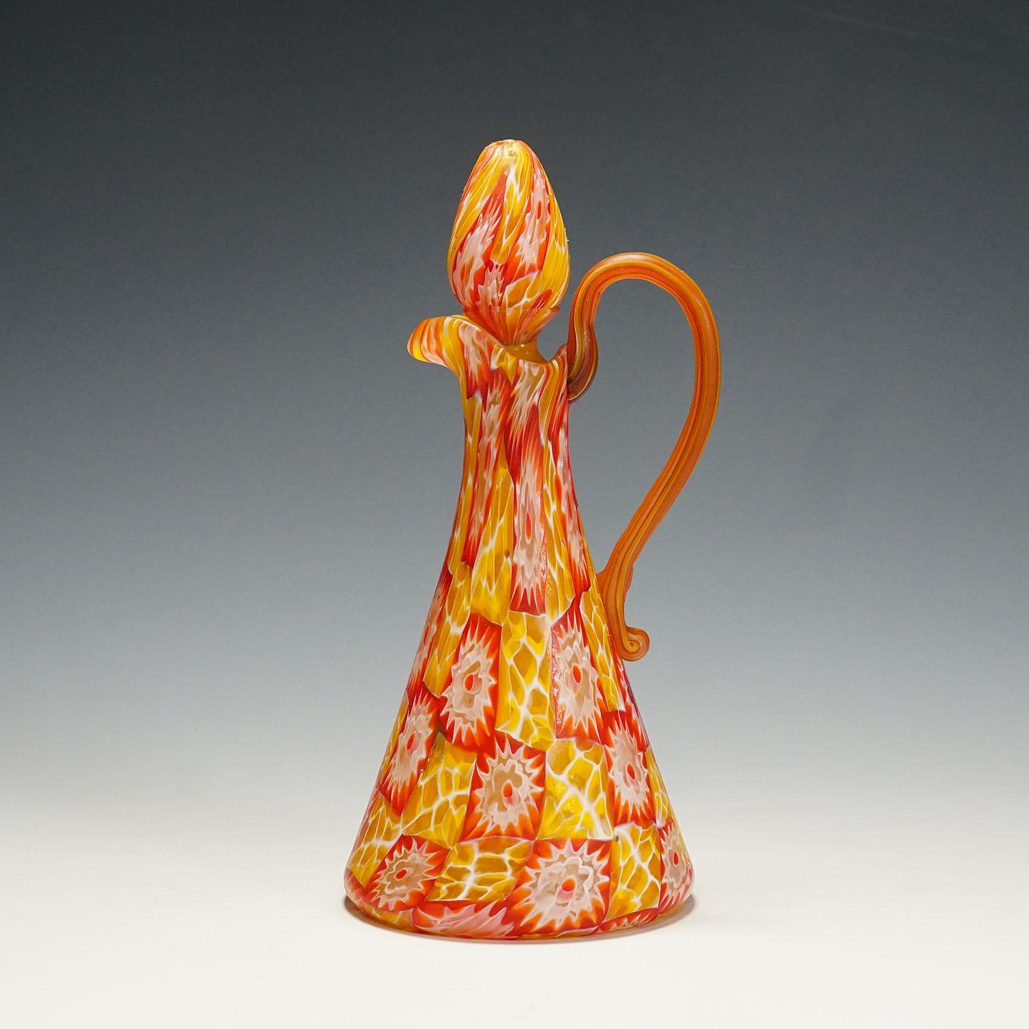 Antique Millefiori Jug with Handles by Fratelli Toso, Murano circa 1920

A rare Millefiore murrine glass jug, manufactured by Vetreria Fratelli Toso, Murano around 1920. Executed with polychrome murrines in red and orange and an acid etched matte