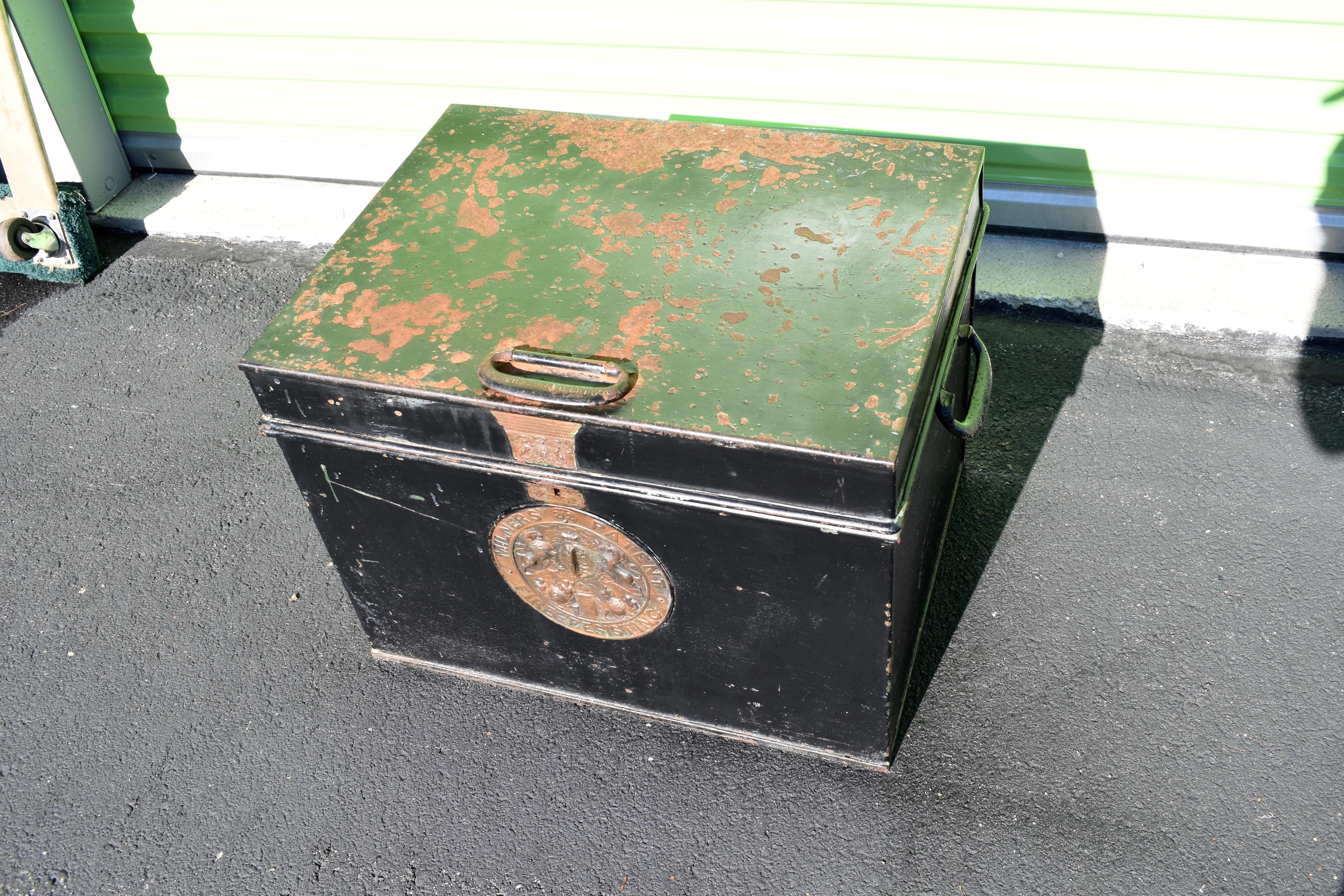 An English antique fire resistant Milners safe, painted green. This safe has a lovely natural patina, and the original bronze Milners plaque. A fire resistant safe box with interesting brass badges and steel carrying handles. The interior with