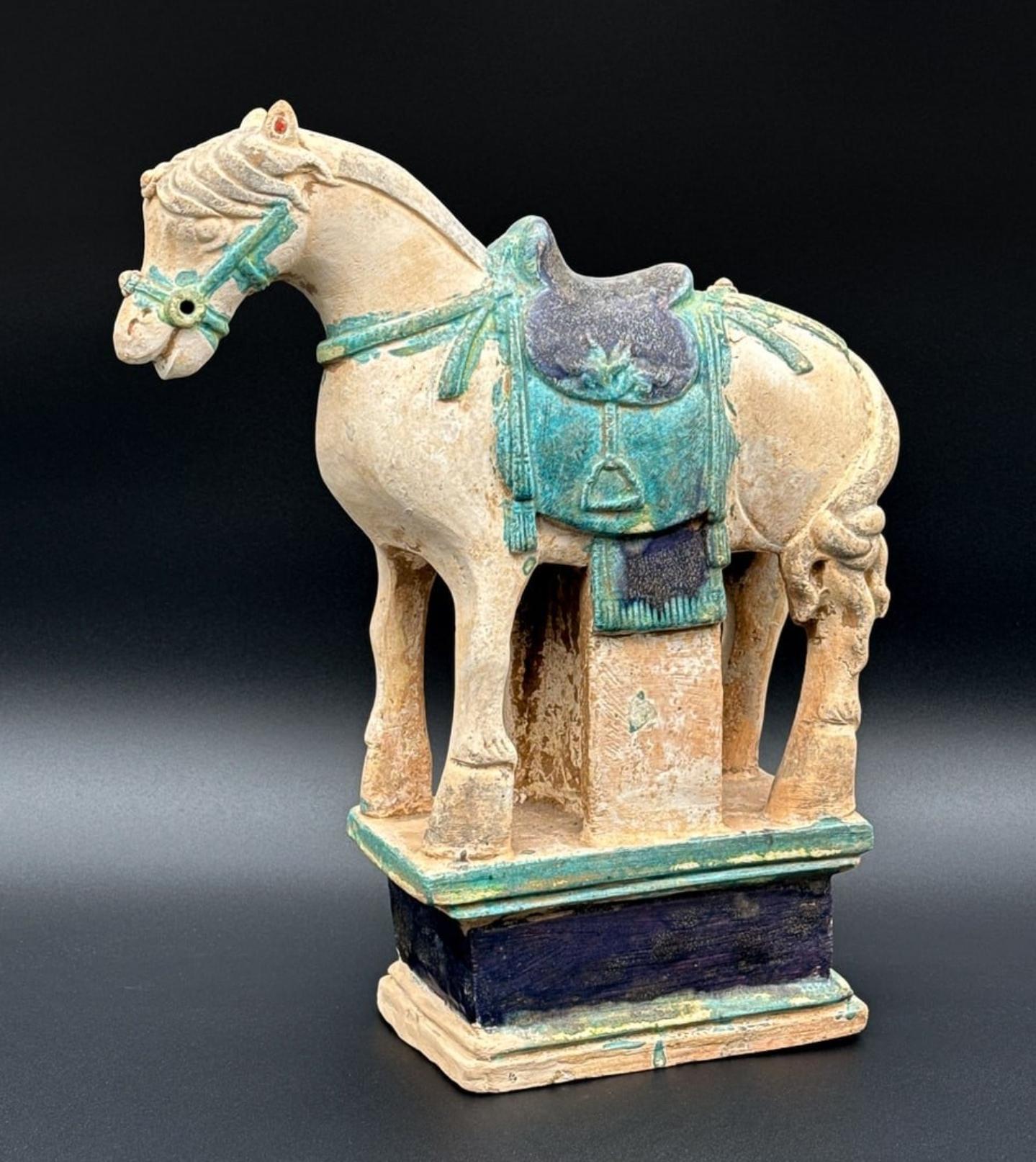 A scarce 600 year old (approx) Chinese pottery Ming Dynasty (1368-1644) large glazed earthenware míngqì tomb figure, modeled as horse sculpture with saddle, stirrups, and integral base.

This hand-crafted Chinese earthenware horse is a type of