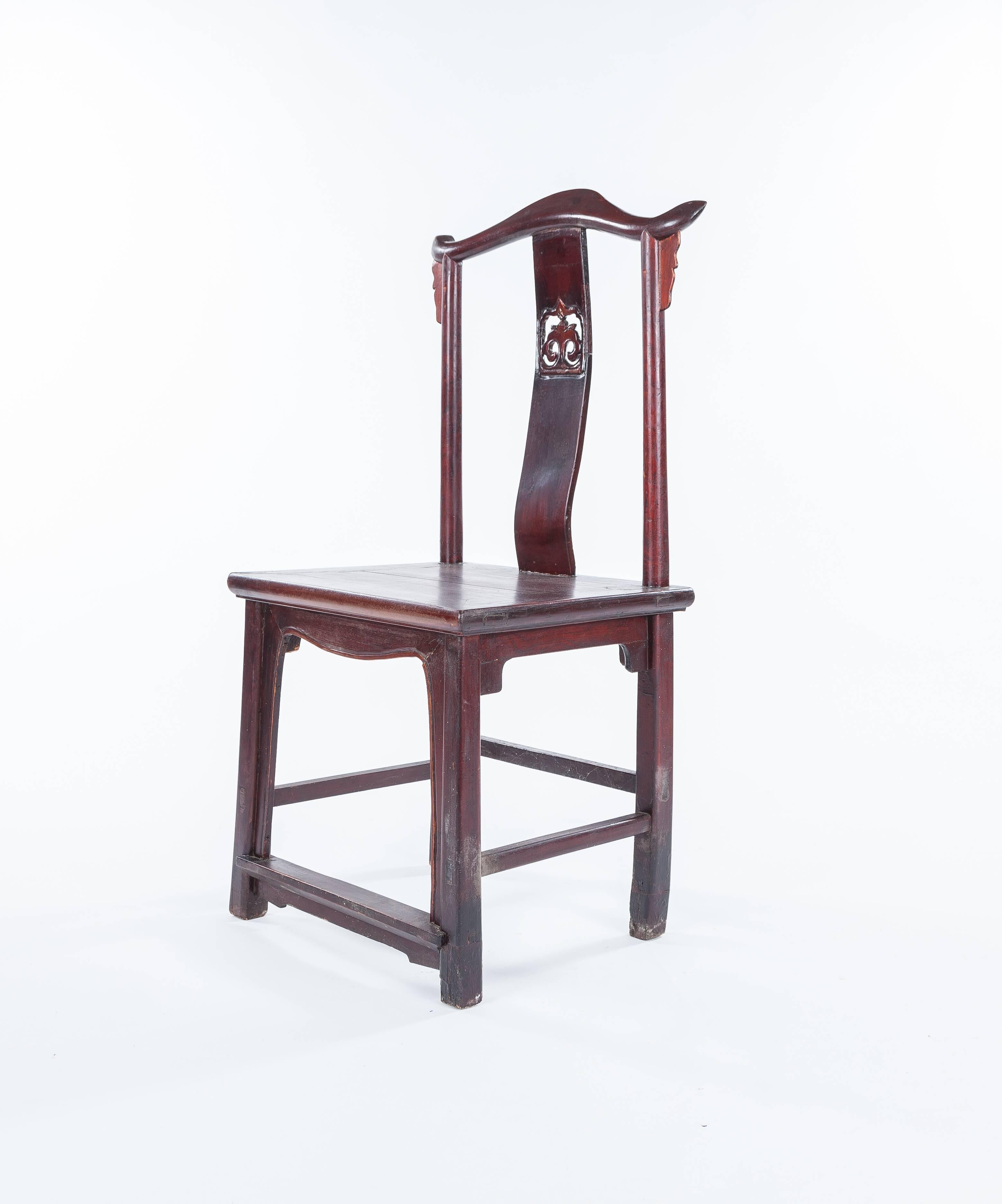 An antique Ming-style Chinese hardwood chair dating to the late 19th century. The chair measures approximately 21
