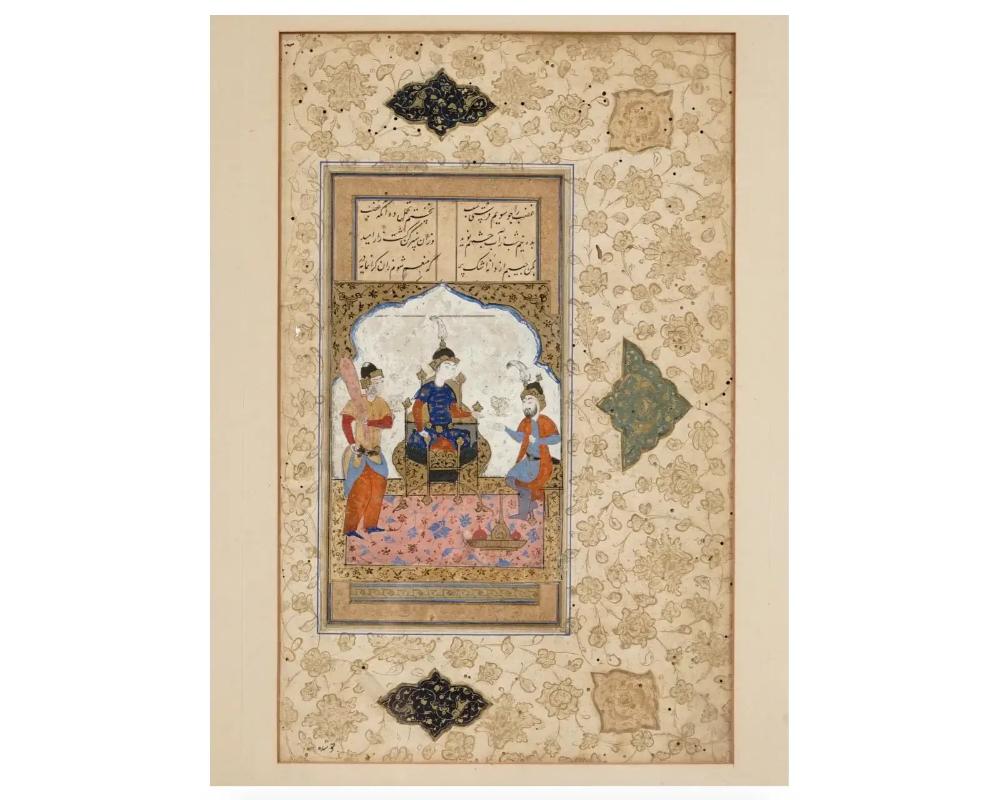 An antique miniature Indo Persian Mughal Art gouache painting on antique manuscript leaf depicting a Royal court scene in bold colors and with fine details. Carefully written with an Arabic calligraphic text upper to the center surrounded by floral