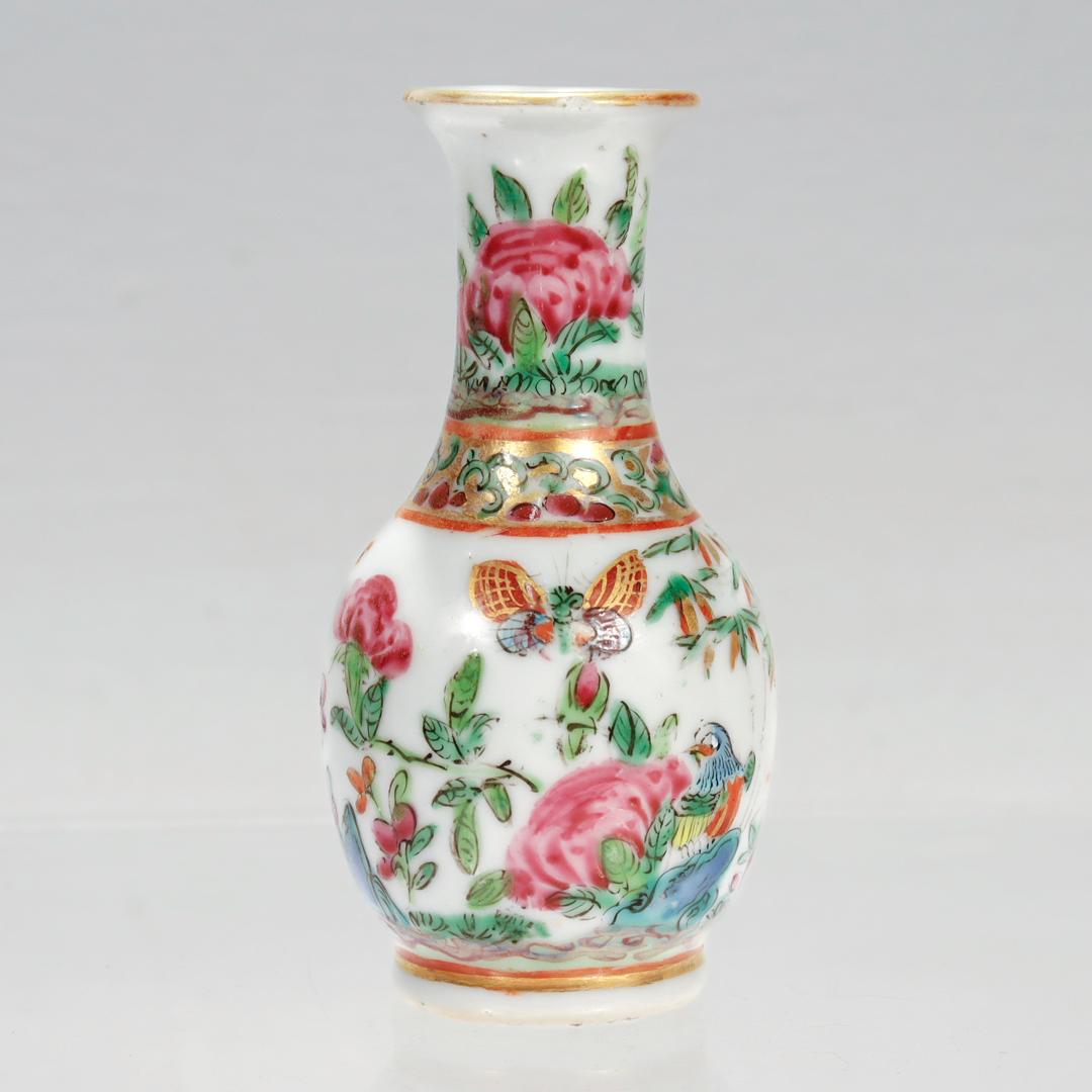 A fine antique miniature Chinese porcelain vase.

Of a vasiform shape with a narrow neck.

In a Rose Mandarin pattern. 

Decorated throughout with pink flowers together with a bird and a butterfly.

Simply a wonderful Chinese porcelain miniature