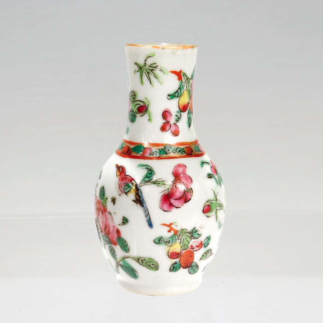 A fine antique miniature Chinese porcelain vase.

Of a vasiform shape with a narrow neck.

In a Rose Mandarin pattern. 

Decorated throughout with pink flowers & orange fruit together with a bird and a butterfly.

Simply a wonderful Chinese