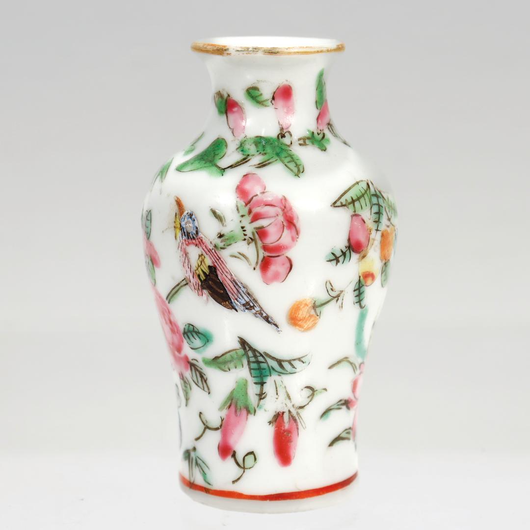 A fine antique miniature Chinese porcelain urn shaped vase.

In a Rose Mandarin pattern. 

Decorated throughout with pink flowers & orange fruit together with a bird and a butterfly.

Simply a wonderful Chinese porcelain miniature vase!

Date:
Late