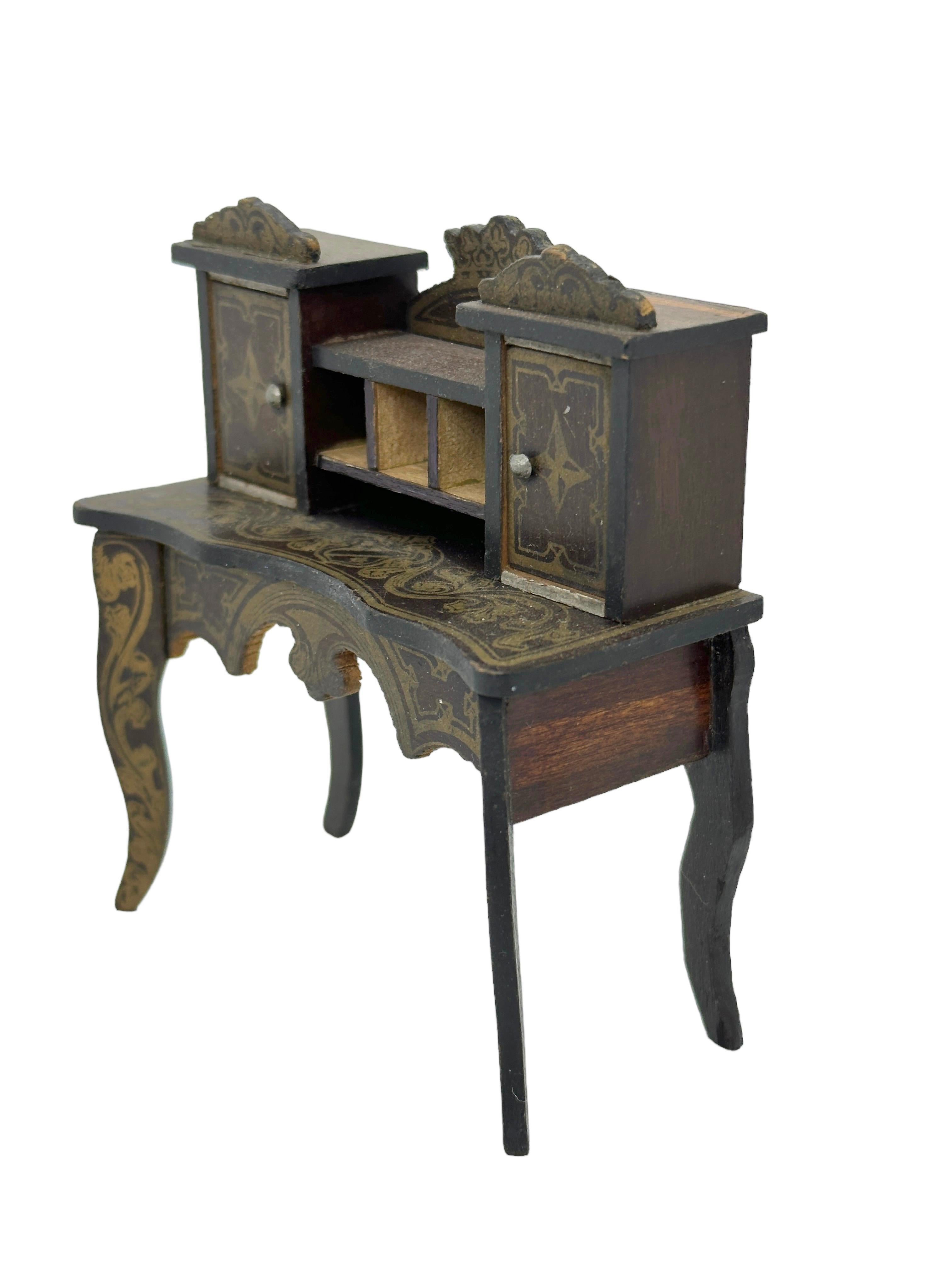 This rare and exquisite miniature antique German wooden Boule Secretary Desk with fine golden transfers, dated about 1860s to 1890s. Made by one of the famous German toy companies. A very lovely Furniture for antique dolls and for dollhouses. 
The